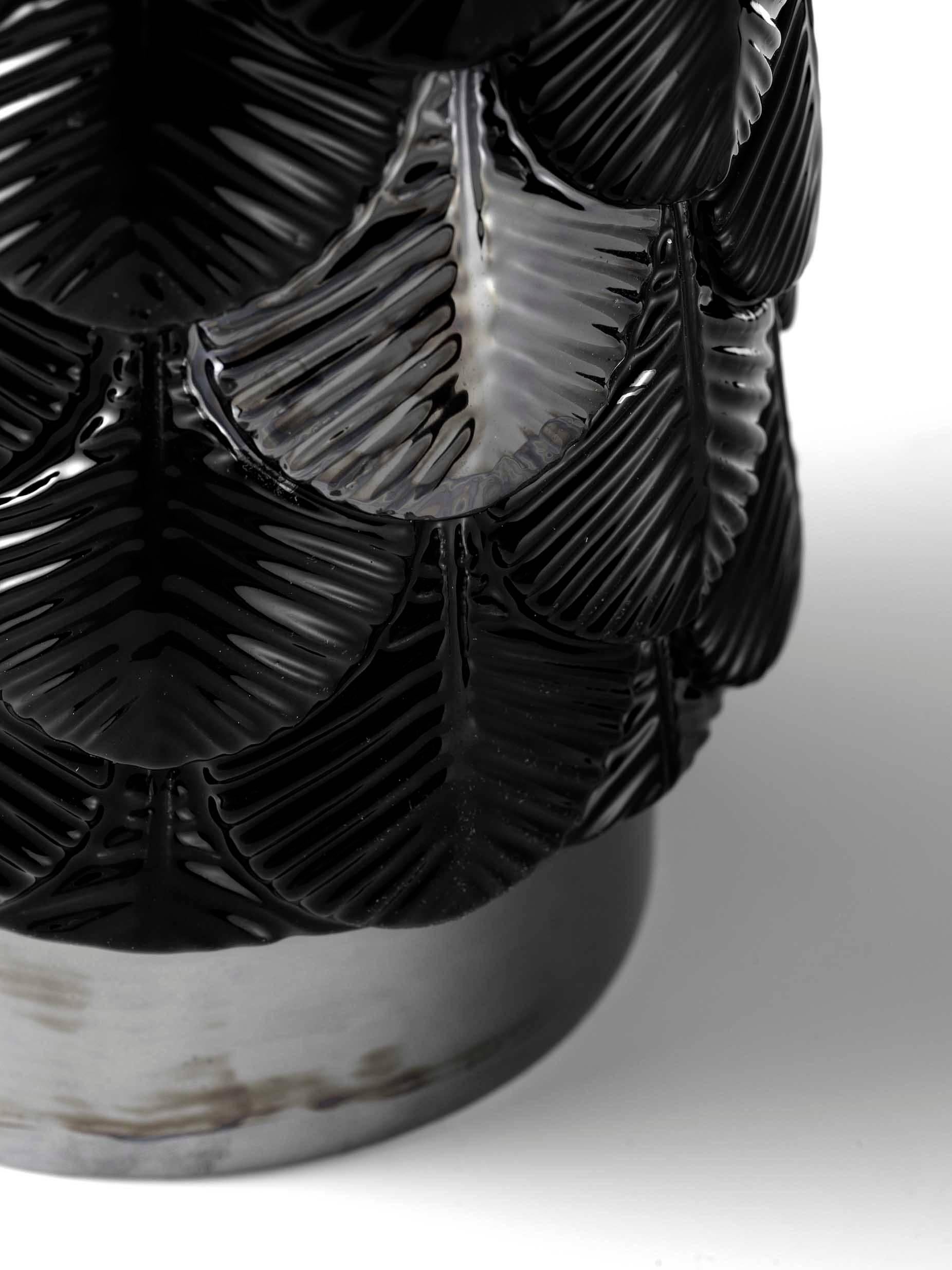 Plumage vase designed by Cristina Celestino for Botteganove is a ceramic vase produced with artisanal methods in Italy and hand-painted with black gloss enamel with some feather and plinth decorated with luster finish.
The interior of the piece is