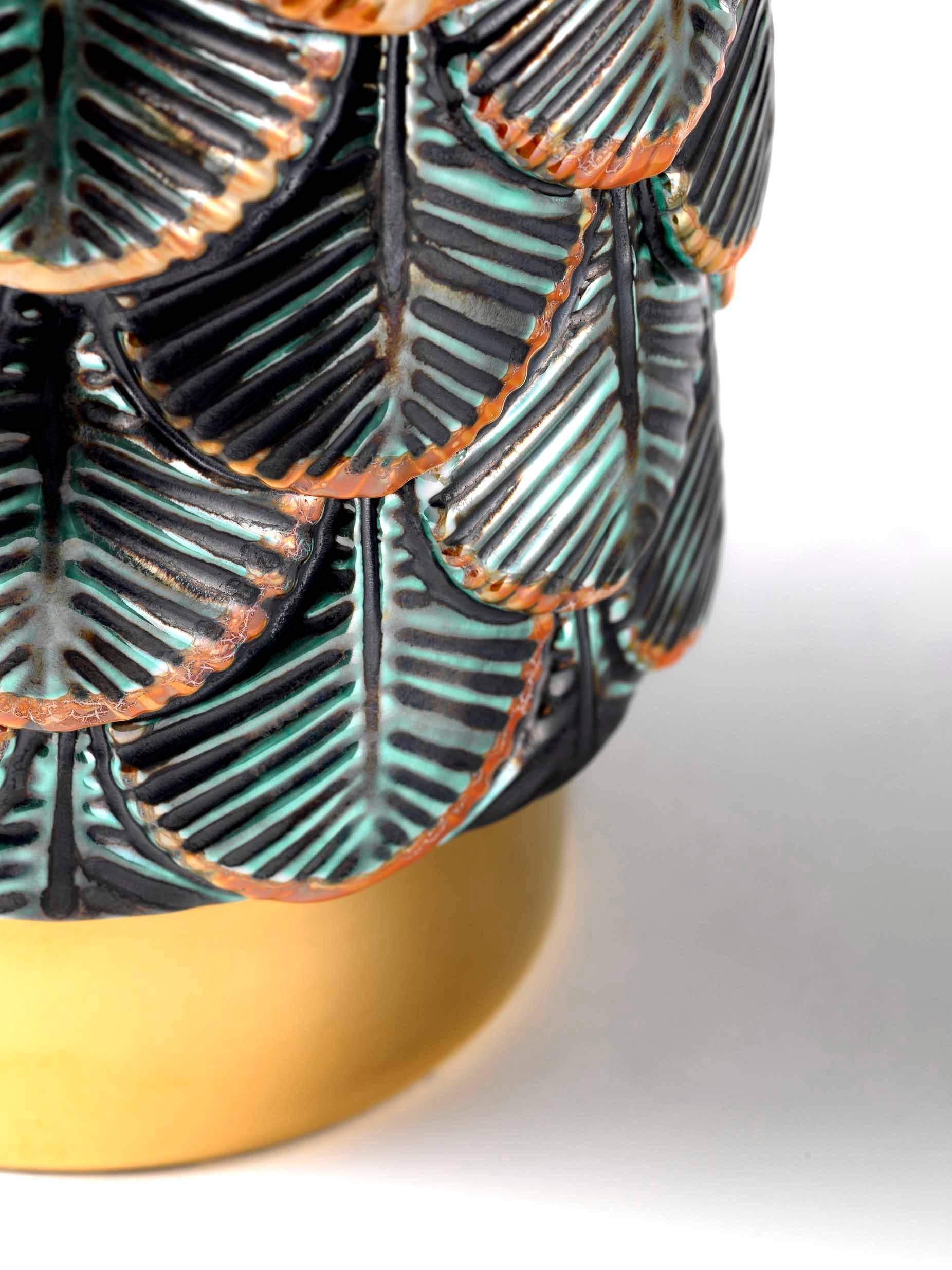 Plumage vase designed by Cristina Celestino for Botteganove is a ceramic vase produced with artisanal methods in Italy and hand-painted with special green and orange metal enamels.
The interior of the piece is white gloss while the plinth is