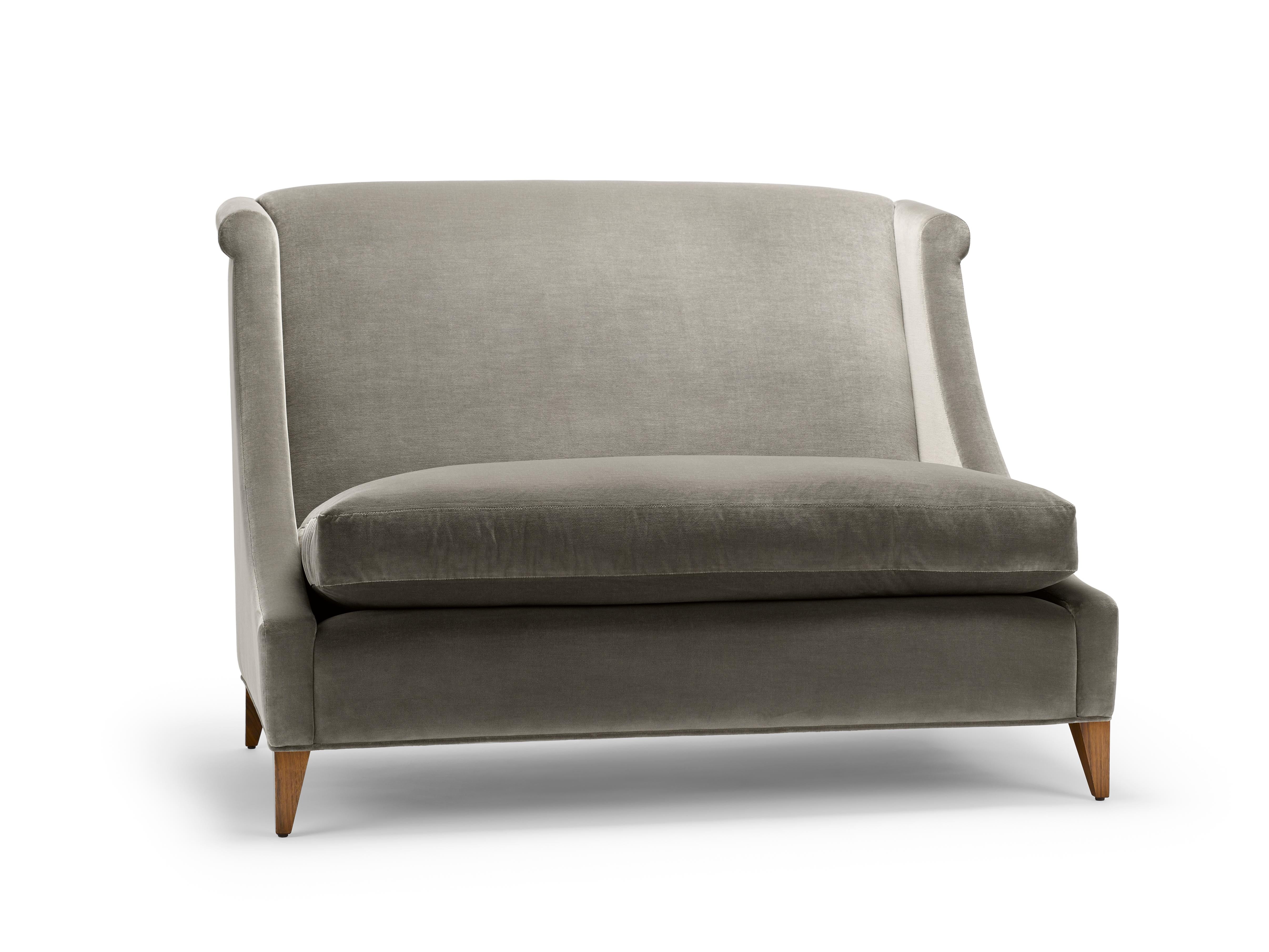 The Vegas Sofa, features a pronounced high back and sweeping curved arms. This special edition is upholstered in Mark Alexander Empire II velvet, colour Otter, with legs in natural oiled walnut. Empire is a luxurious velvet with a subtle horizontal