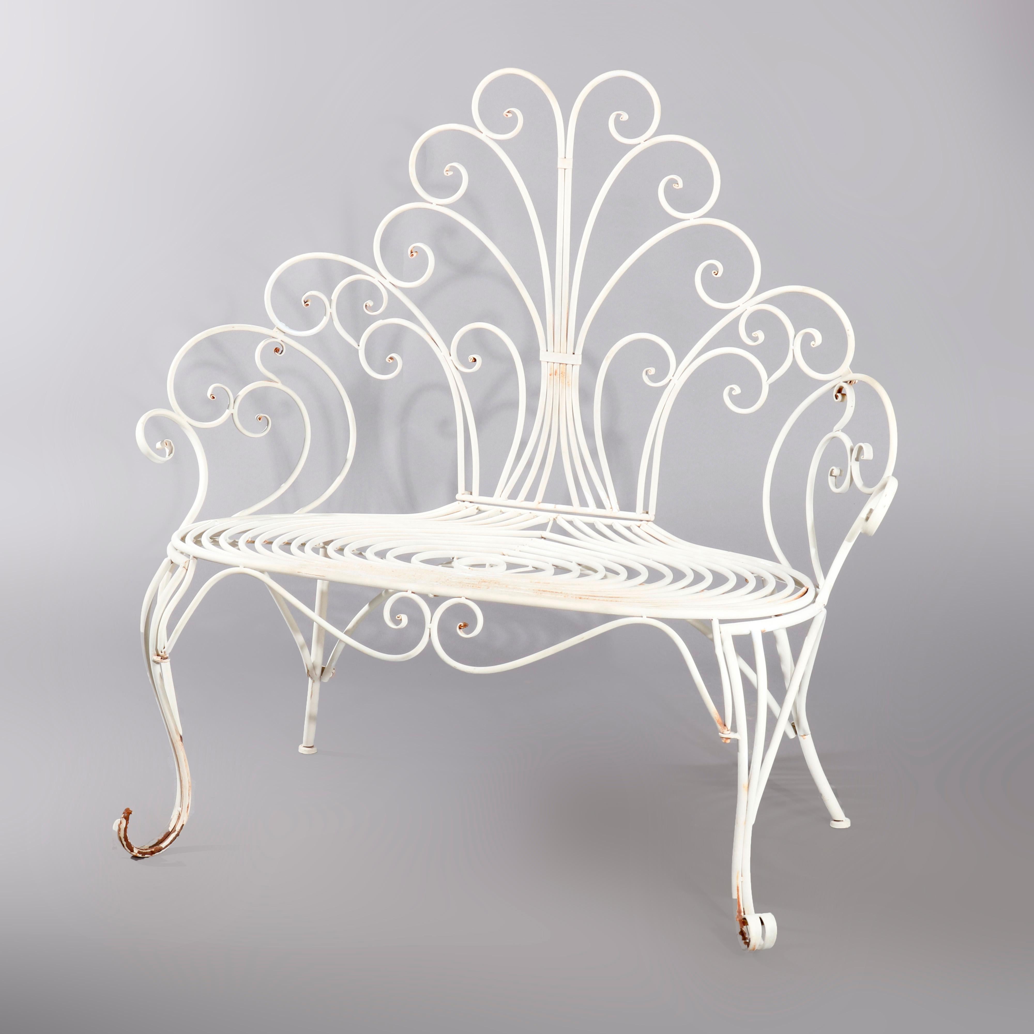 A contemporary Victorian style garden bench offers wire construction with scrolled high back and arms, raised on cabriole legs terminating in scrolled feet, painted white, 20th century

Measures: 46