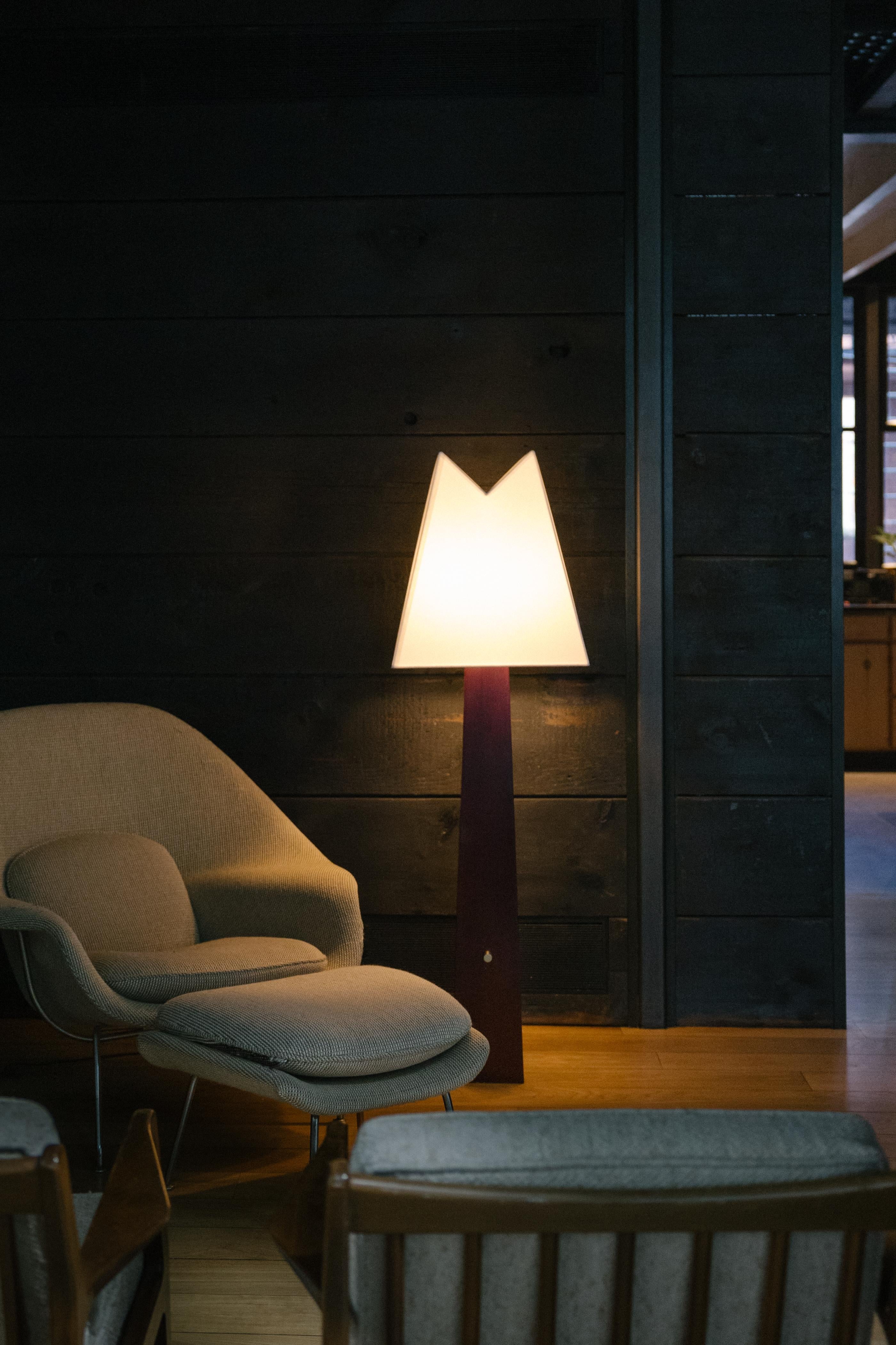 Born of nostalgia, the Alpine Lamp echoes natural forms and mountainous contours. The natural wooden base grounds the piece in earthy materials, evoking the altitude of Utah forests; the “V” of the lampshade mirrors the notch in Lone Peak, a