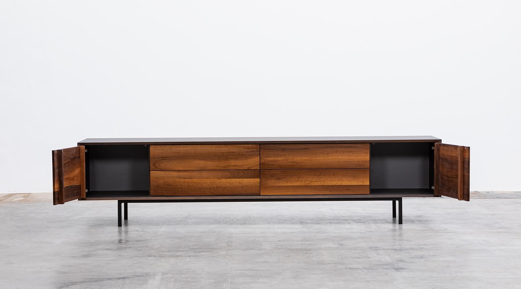 Sideboard by contemporary German artist Johannes Hock. The front of the doors and drawer of this unique piece are made of massive caucasian walnut wood, the corpus is in black hpl on black metal legs. Manufactured by Atelier Johannes Hock.

Hock