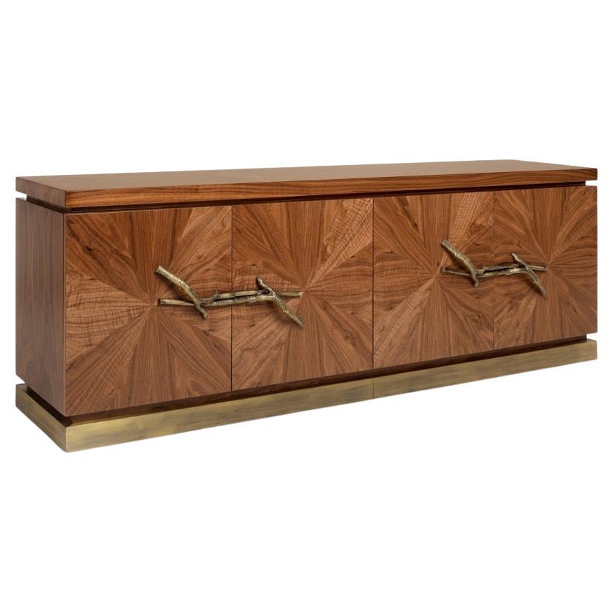 The woodwork of the Walnut, made with inlay marquetry technique, evokes the first rays of sunshine passing through naked tree branches. The unique door handles are made from tree branches in brass casting mold.
Body: American Walnut.
Drawers and