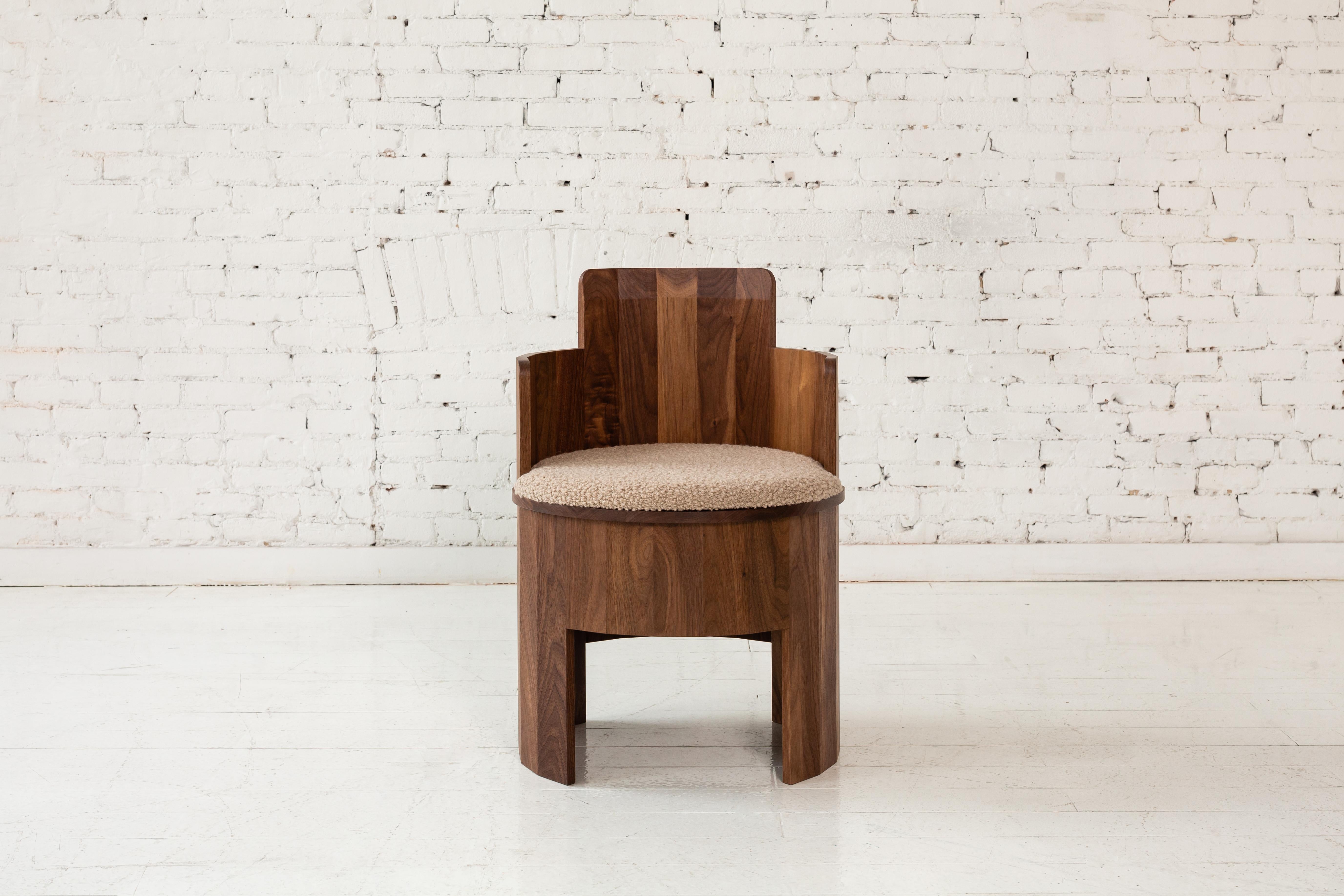 This wood side chair is a part of the new Cooperage Dining collection. Each piece features large faceted round elements that with its namesake reference the traditional cooper's trade of making barrels.

The occasional chair table is shown in