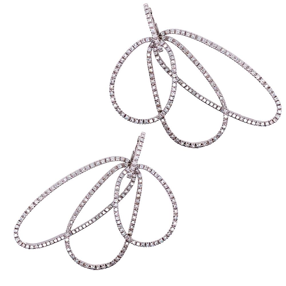 Three asymmetrical loops make up these stunning modern drop earrings which have been masterfully handmade from 18-karat white gold and 4.4 carats of gorgeous G VS-rated diamonds.  

These earrings weigh 27.7 grams and close with posts and