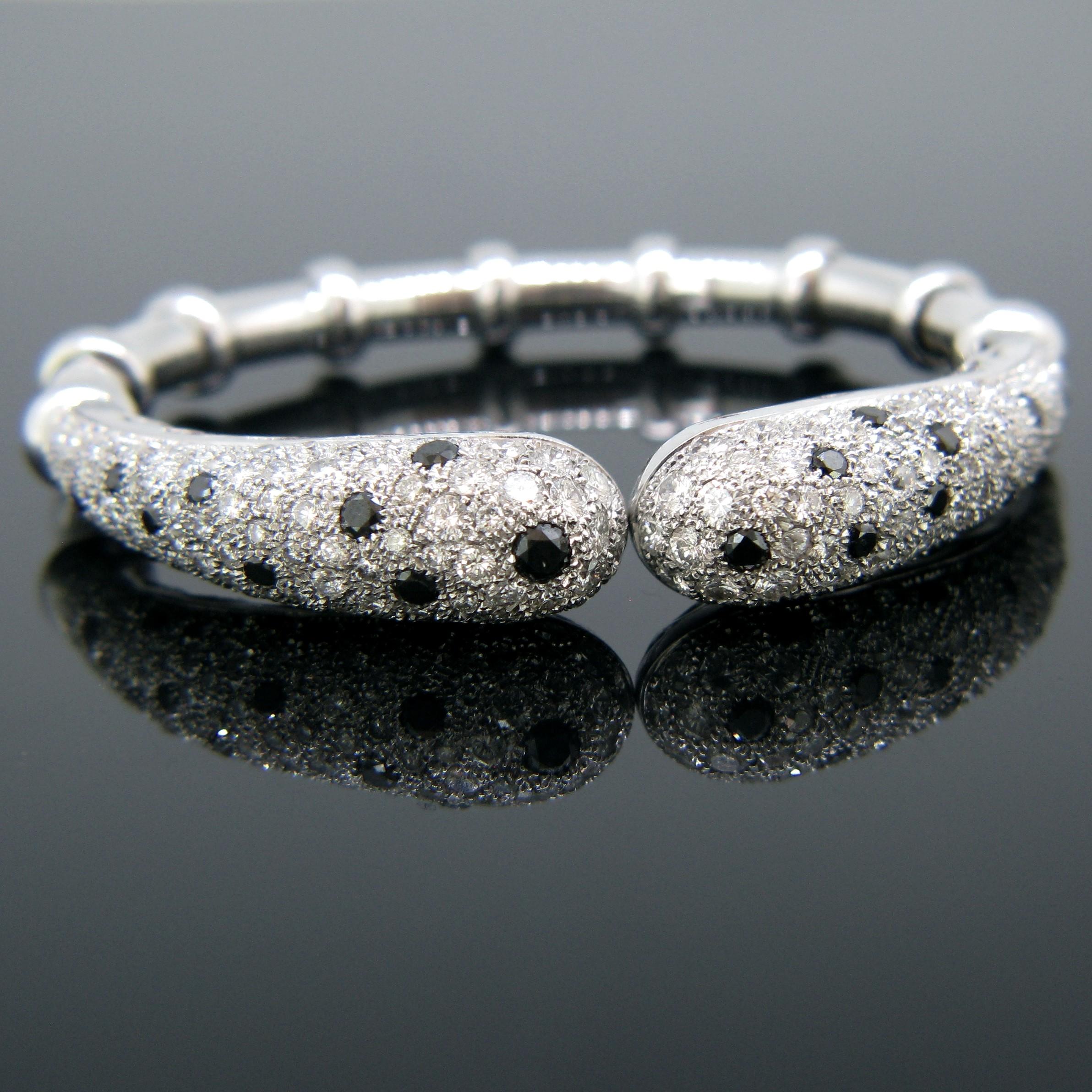 This beautiful bangle is fully made in 18kt white gold. It is set with 24 black diamonds and 190 White Diamonds. The total diamond carat weight is around 4.30ct. It is in excellent condition and very comfortable to wear. It is a great addition to