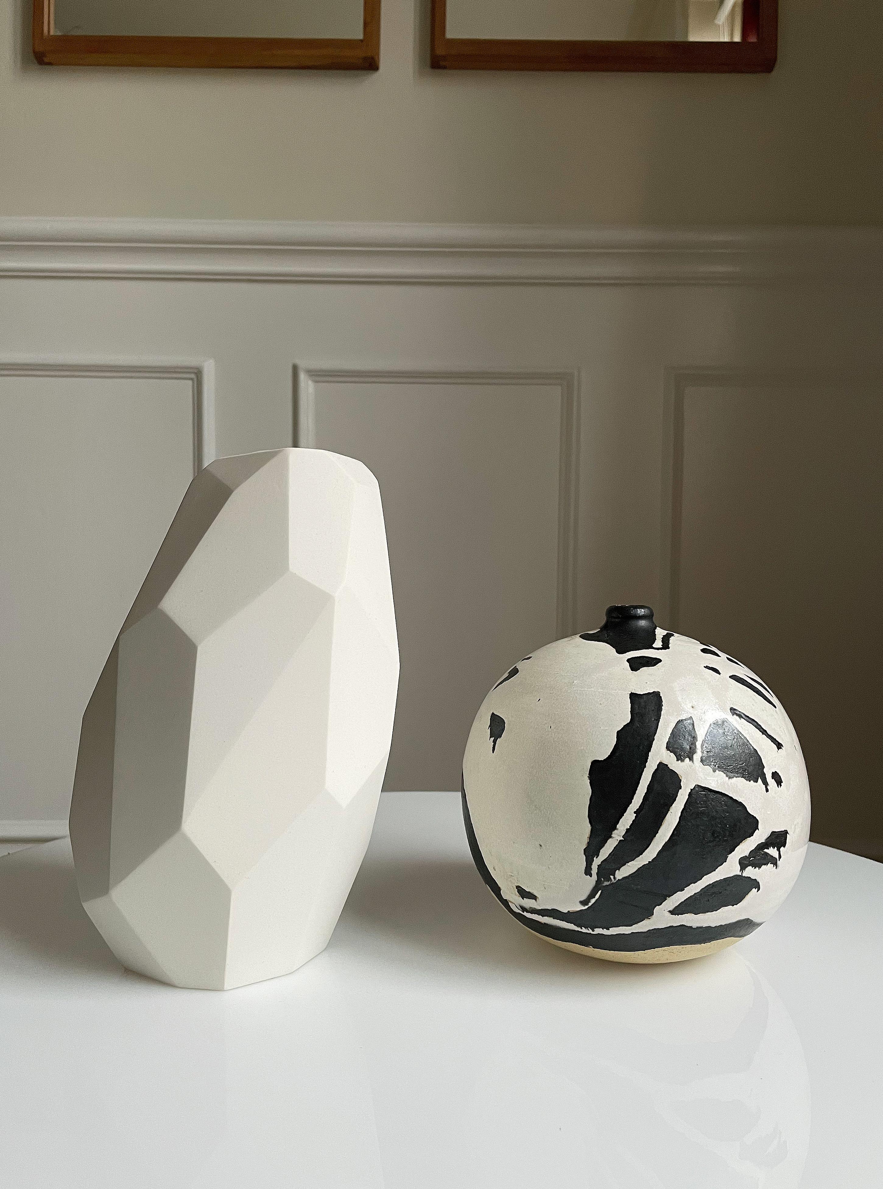 Limited edition contemporary white ceramic sculptural vase by Danish ceramic artist Anne Jørgensen for AJ Ceramics. The sculptural slanted design consists of multiple sharp angles and different size surfaces from top to base, all sanded by hand.