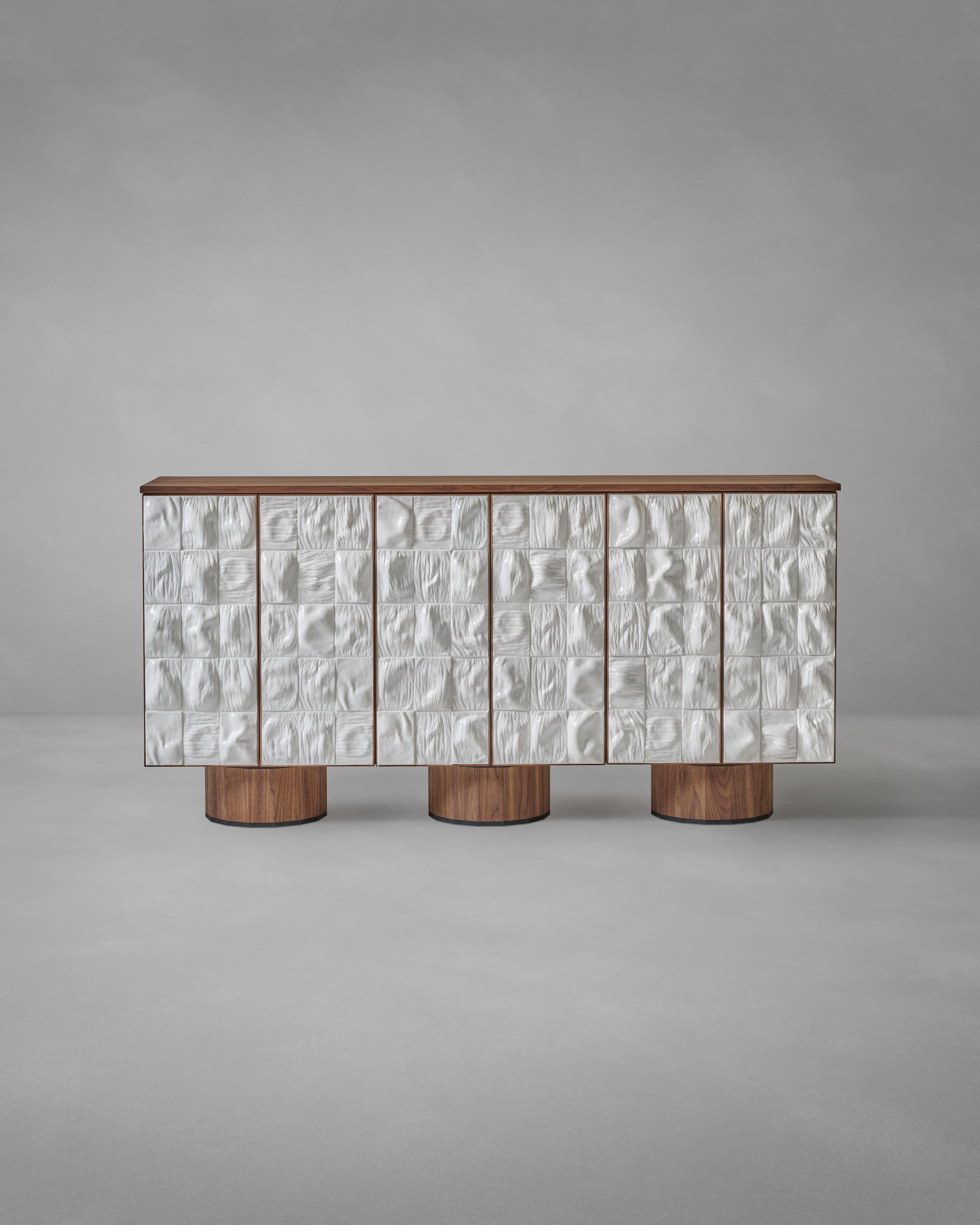 'Surfaced Cabinet' by REM Atelier 
Material: Walnut wood, glazed ceramic
Dimensions: H 91 x W 182 x D 42,5 cm
Specificity: 3 feet - 6 doors
Year: 22025

The clad 'Surfaced Cabinet' blends different material characteristics within one functional