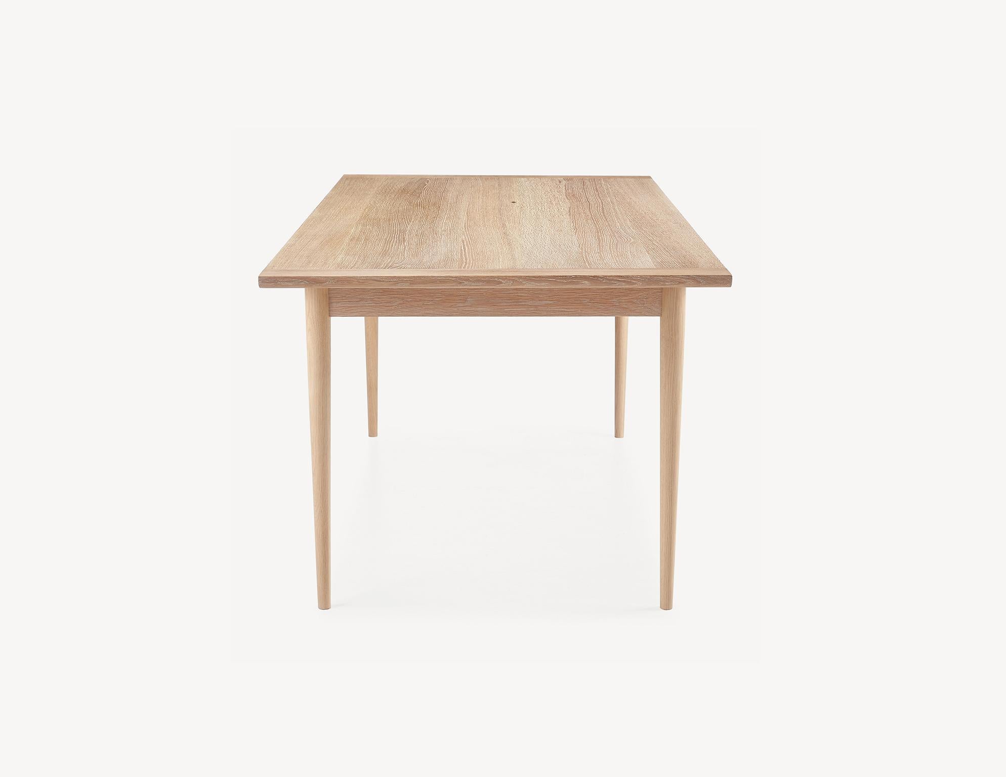 Carefully selected materials and refined proportions give the Lakeshore table an elegant, rational quality. Brass-pinned breadboard ends and quarter sawn white oak top are centuries-old craft techniques employed to keep this solid wood top stabile