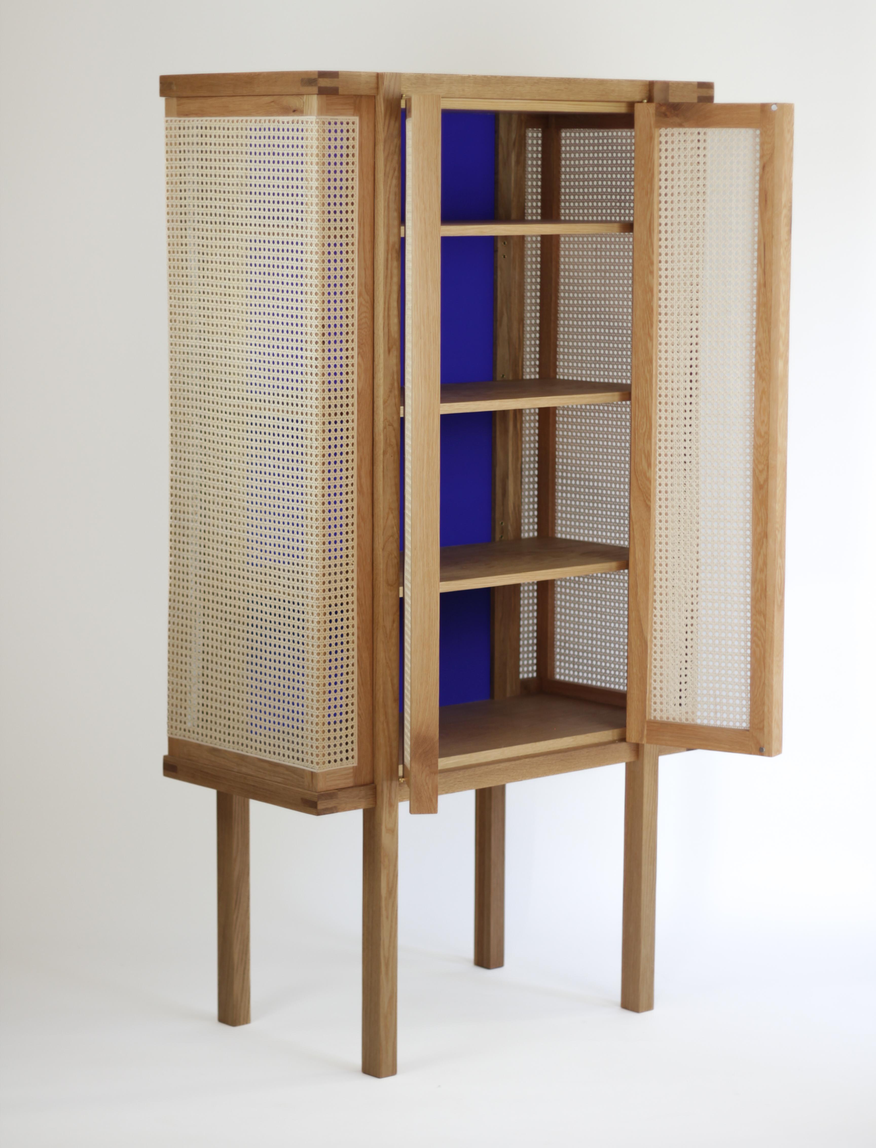 This Curiosity cabinet is superbly detailed as well as practical. It serves as a cabinet bar, pantry or linen closet. Offering ample room for storage with three adjustable shelves. It is constructed by hand with solid wood and caned rattan panels