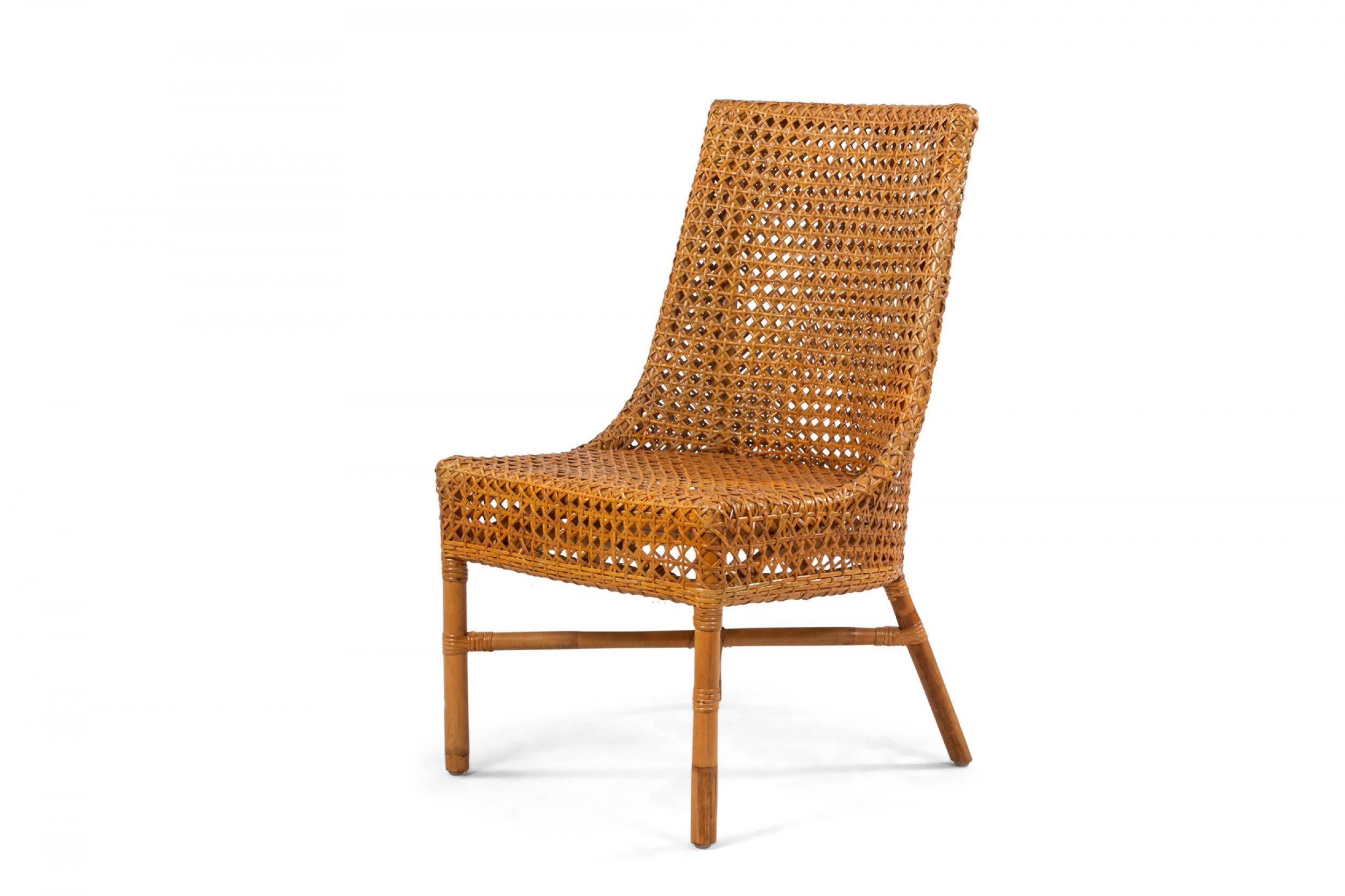 36 Contemporary curved back natural woven wicker side chairs supported on faux bamboo legs connected by a stretcher (PRICED EACH).
