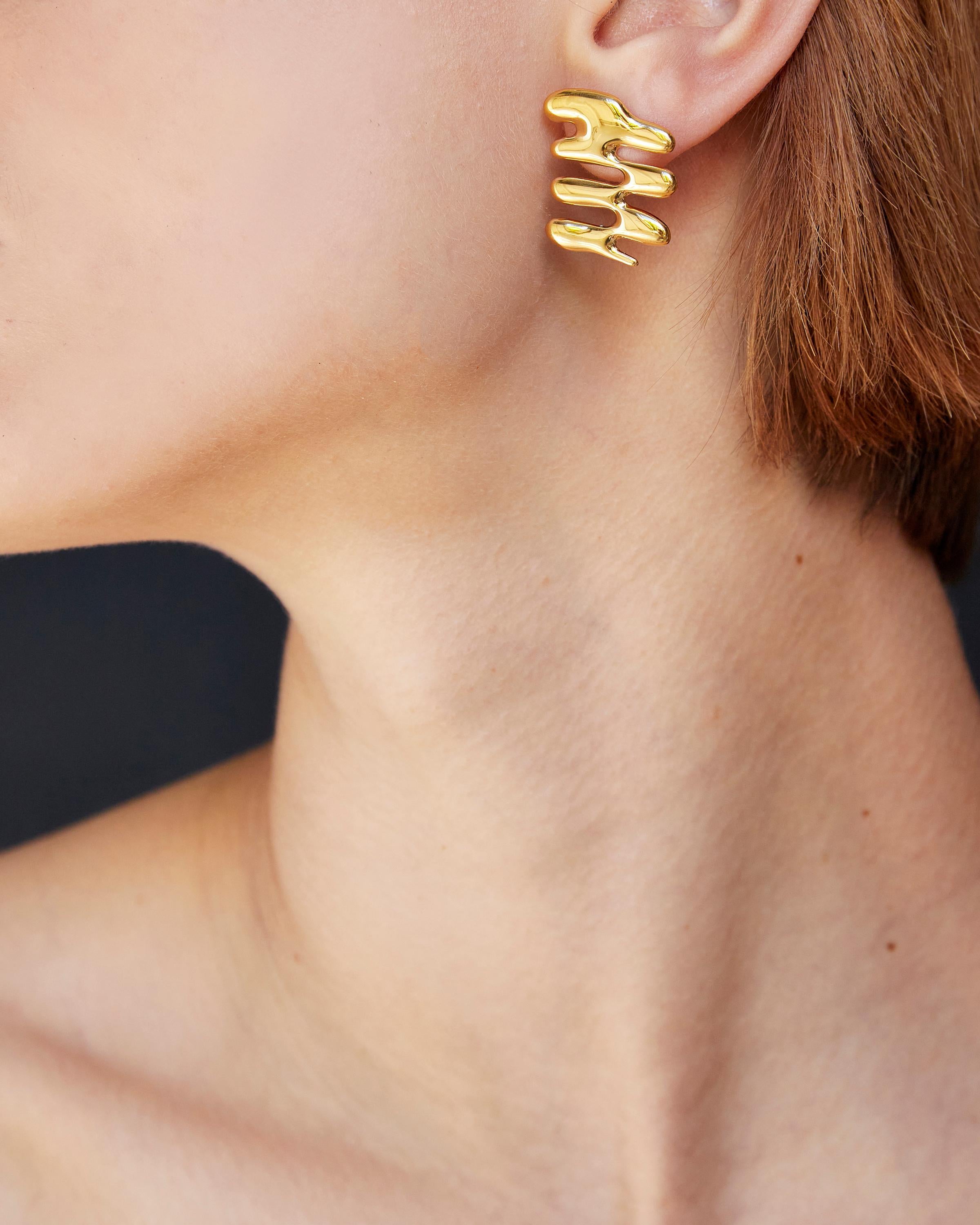 BAR Jewellery, London UK, SMALL VEGA EARRINGS, Gold Plated 

The Small Vega Earrings are asymmetric, with natural curved lines that flow like water and sparkle in the light. Inspired by Frank Gehry's iconic 'wiggle' chairs and created impulsively