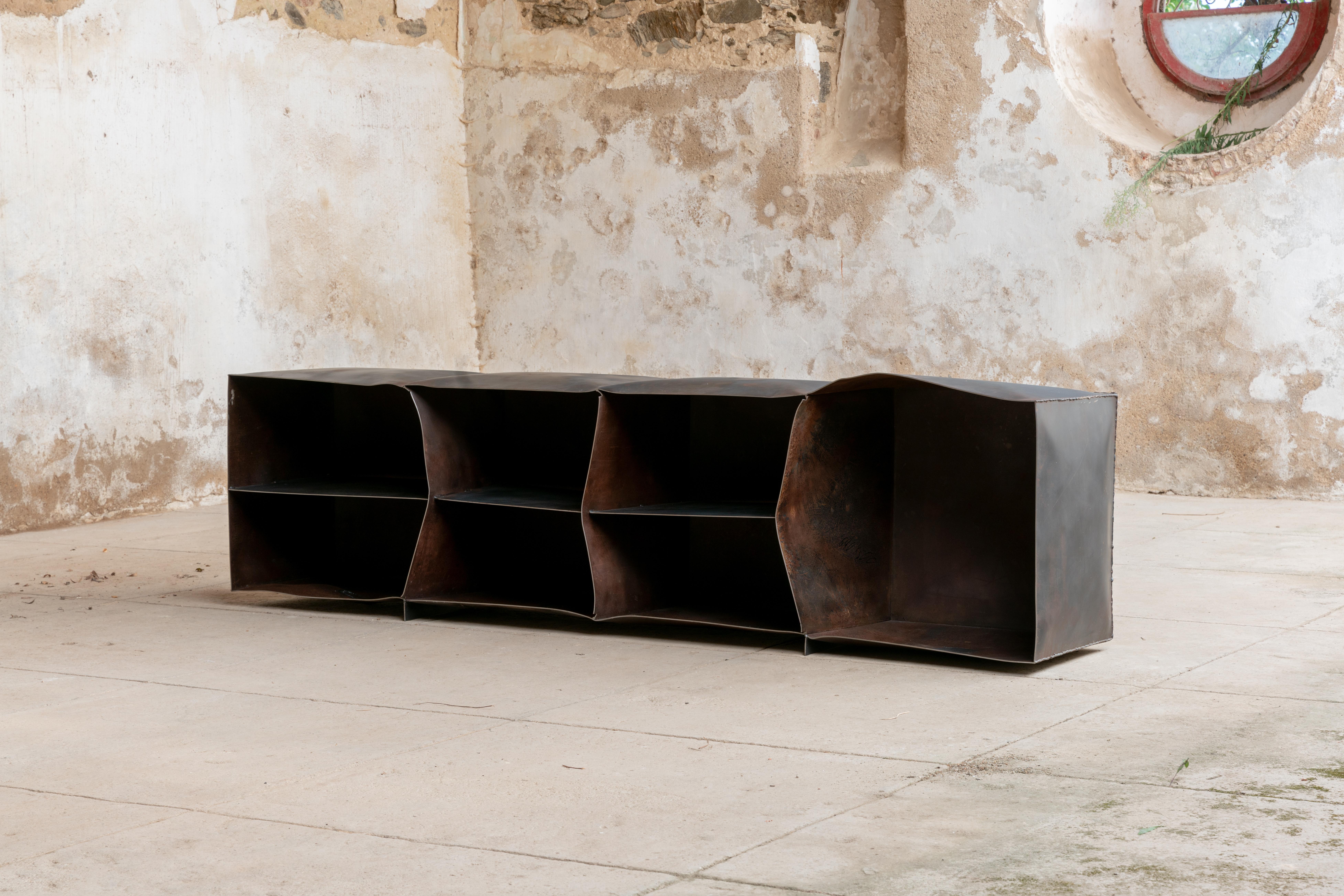 One-of-a-kind Sideboard.

The object is made from a Metal Volume that has been spontaneously shaped by an explosion, and hand treated to reach a soft touch. Part of a series of three furniture pieces, Metal Volumes have been exploded at various