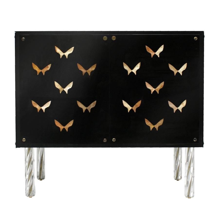 Pair of contemporary sideboards designed by L.A. Studio. Structure made of solid wood covered with dark glass and decorated with butterflies made of brass. Composed of two folding doors and four turned legs made of solid glass.

Our main target is