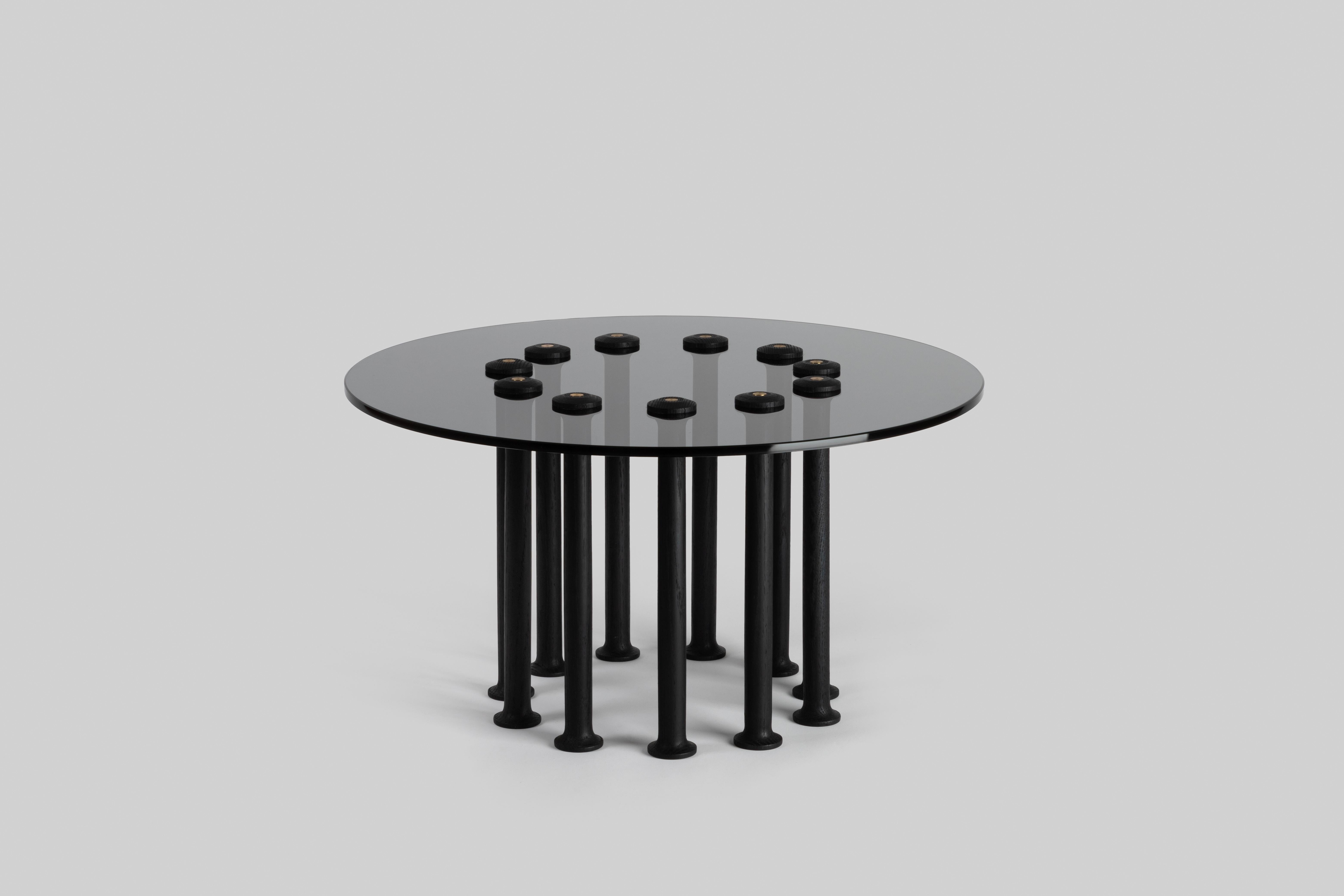 Molinillo is a collection of auxiliary and center tables designed by Colección Estudio. Each of the legs of the tables were made manually and its intense black color was achieved by carbonizing the wood, a finish inspired by mills. The covers, on