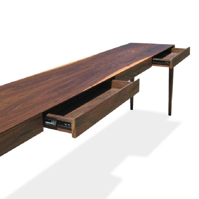 This sleek and elegant console table features hidden drawers, mitered into the face of the front edge. Shown in natural Argentine Rosewood and available in any species or finish.

About Costantini Design

Costantini is a furniture design and
