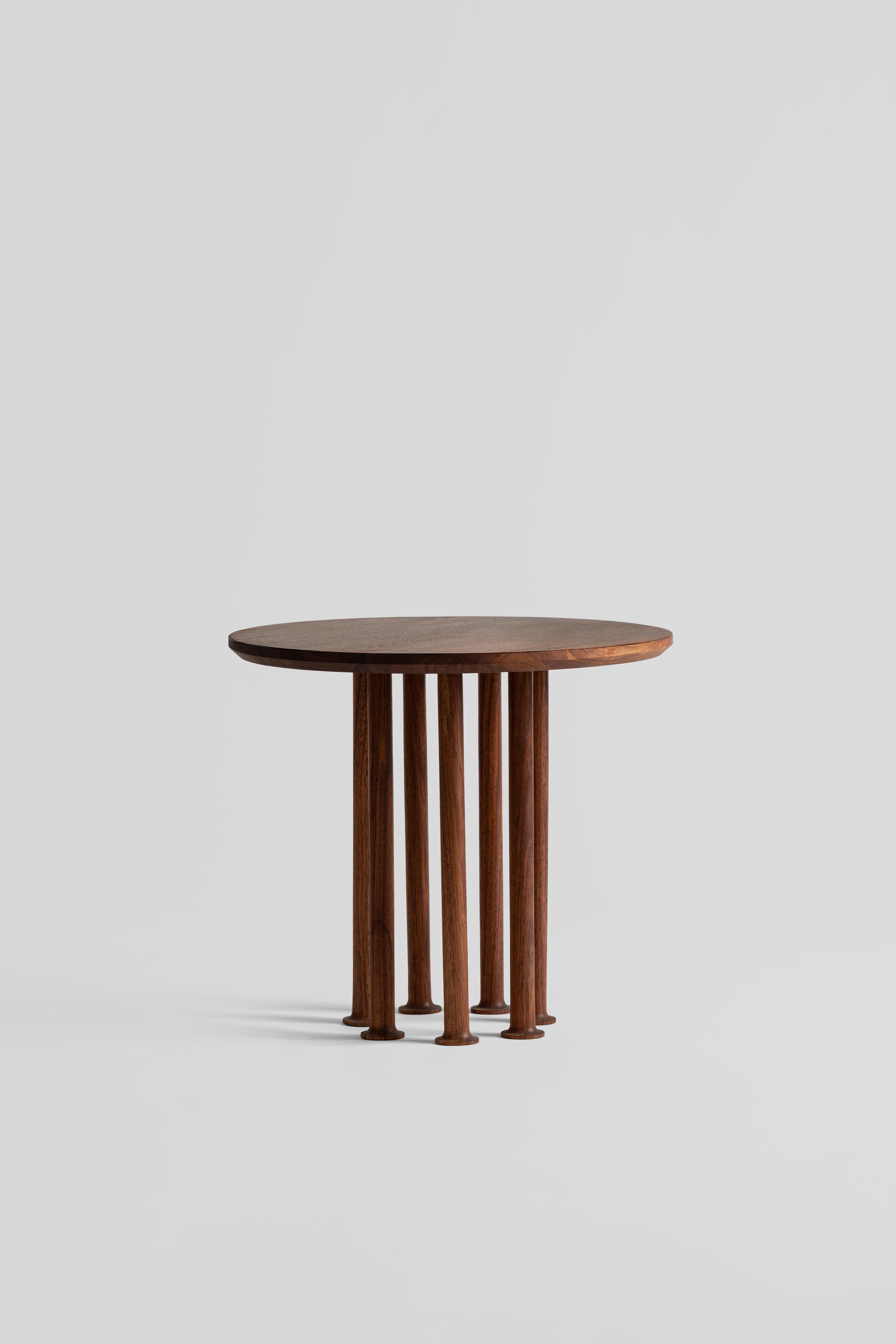 Molinillo is a collection of auxiliary and center tables designed by the Colección Estudio. Each of the legs of the tables were made manually and its intense black color was achieved by carbonizing the wood, a finish inspired by mills. The covers,