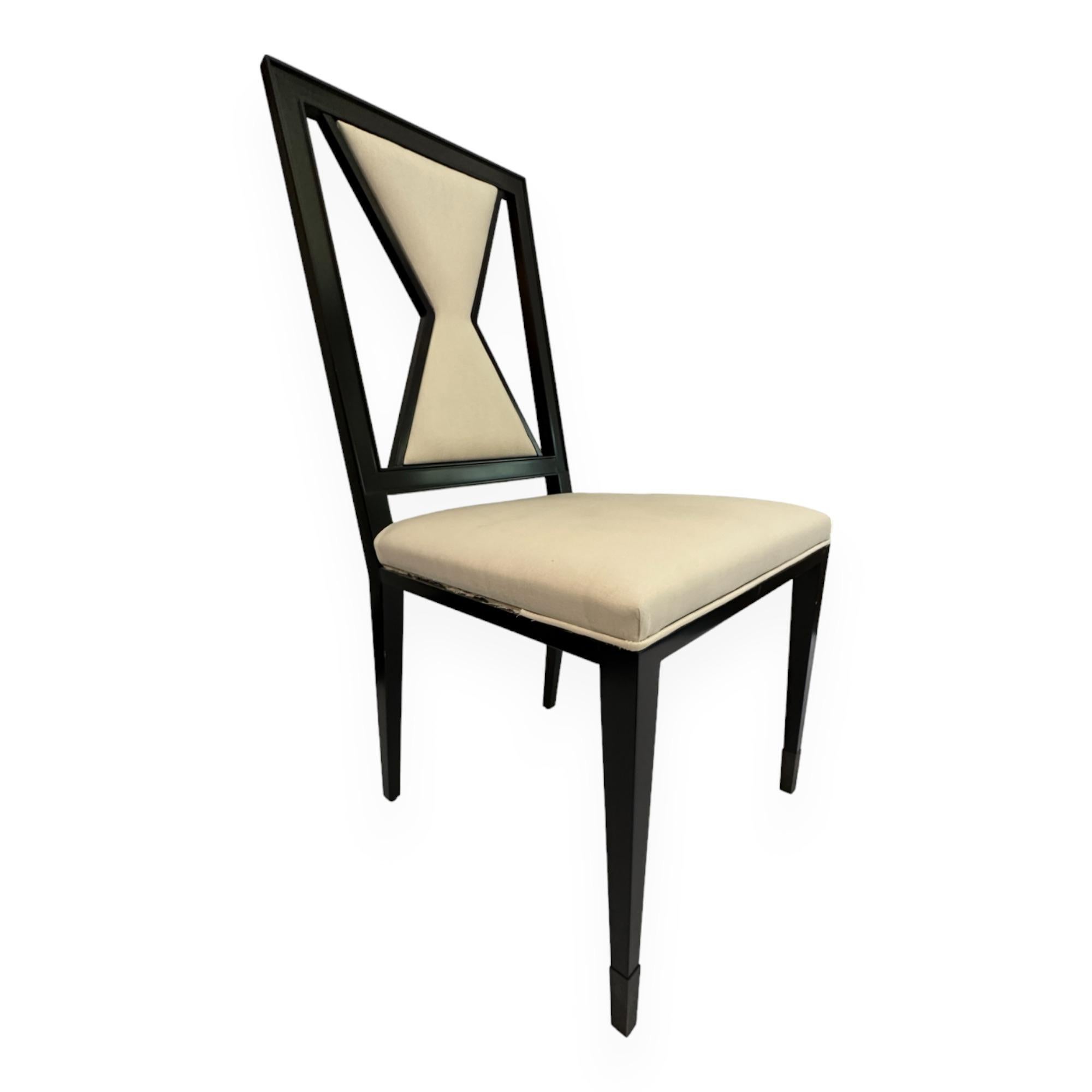Contemporary wooden armchair design by Juan Montoya. This unique black lacquered piece has a geometric shaped backrest. Its design and color allows for different upholstery fabric and patterns. 