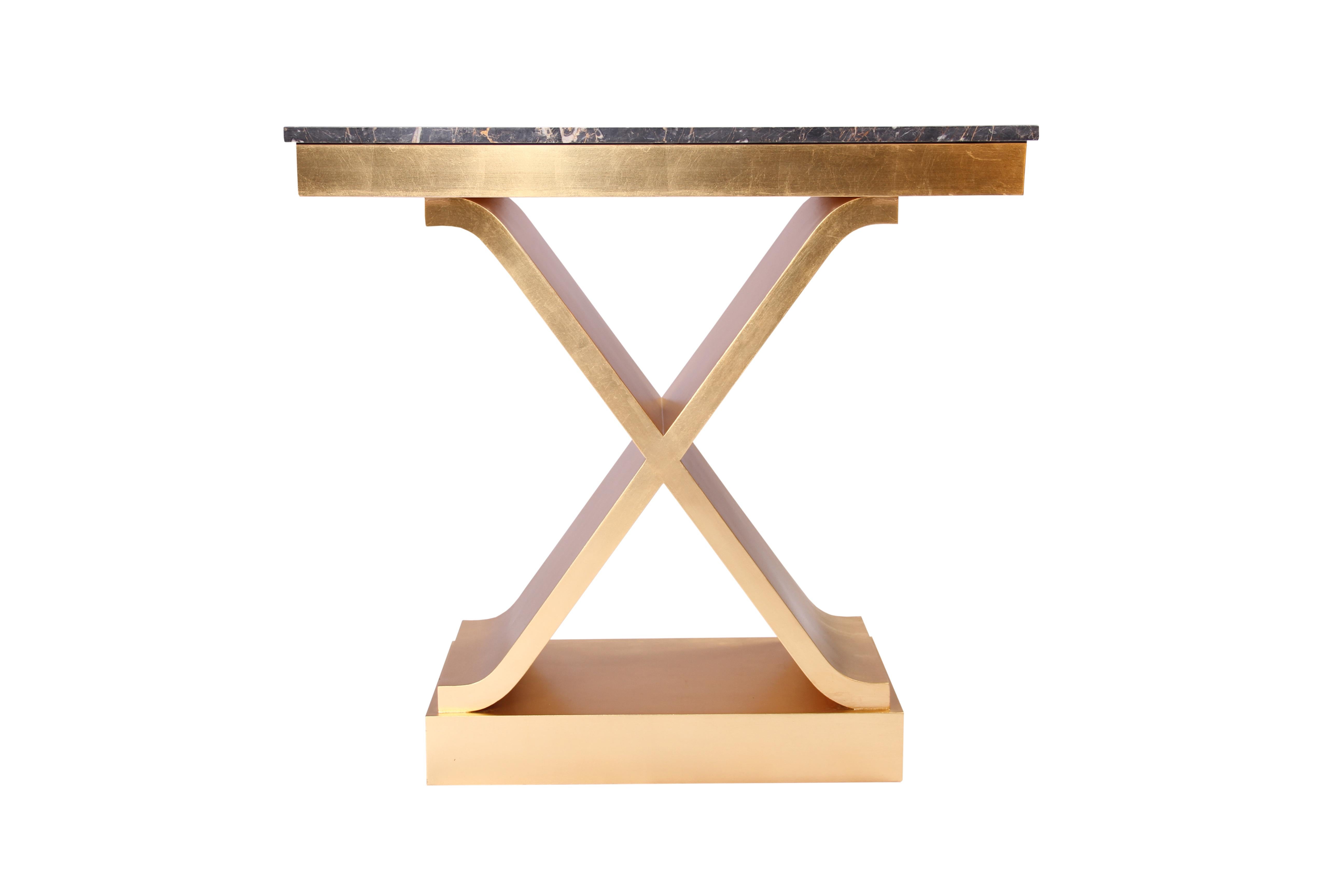 Contemporary hand finished gold leaf gilded console table in a wooden frame and a black marble top.