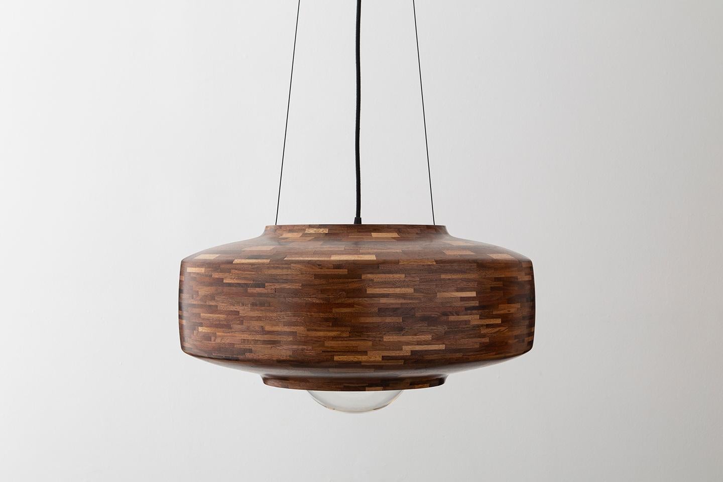 The STACKED Saucer Pendant lights are customizable in virtually any wood and any finish. The one's shown in this listing include Cherry and Walnut, both in a Natural Finish. However, Specialty Finishes are also available, such as Blackened,