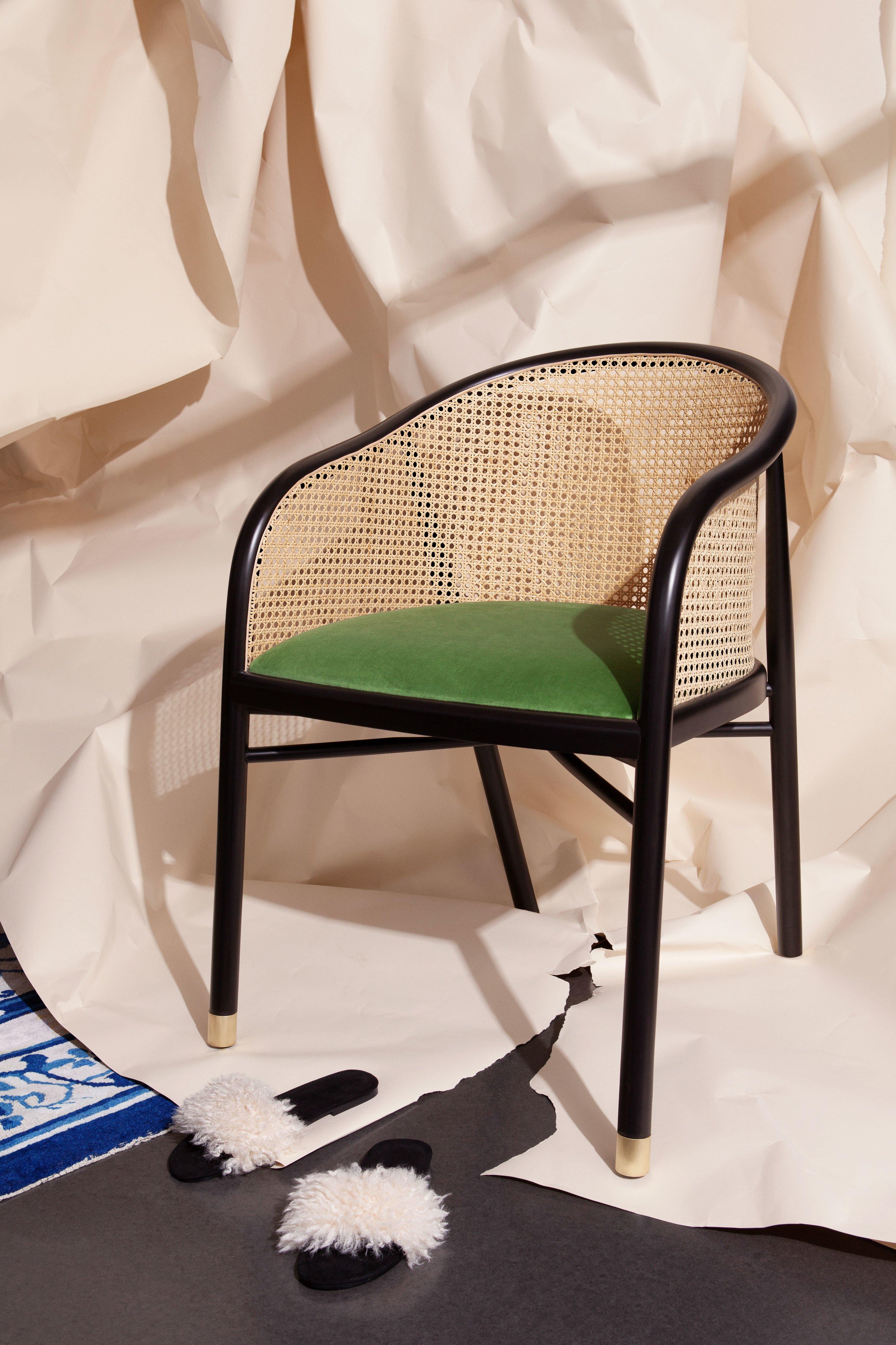Classic but with a contemporary touch, this chair can be set in an entrance hall, as a desk chair, or an armchair at the dining table. Made of black beech-wood and natural cane with upholstered seat in a choice of leopard print, green, or brick red