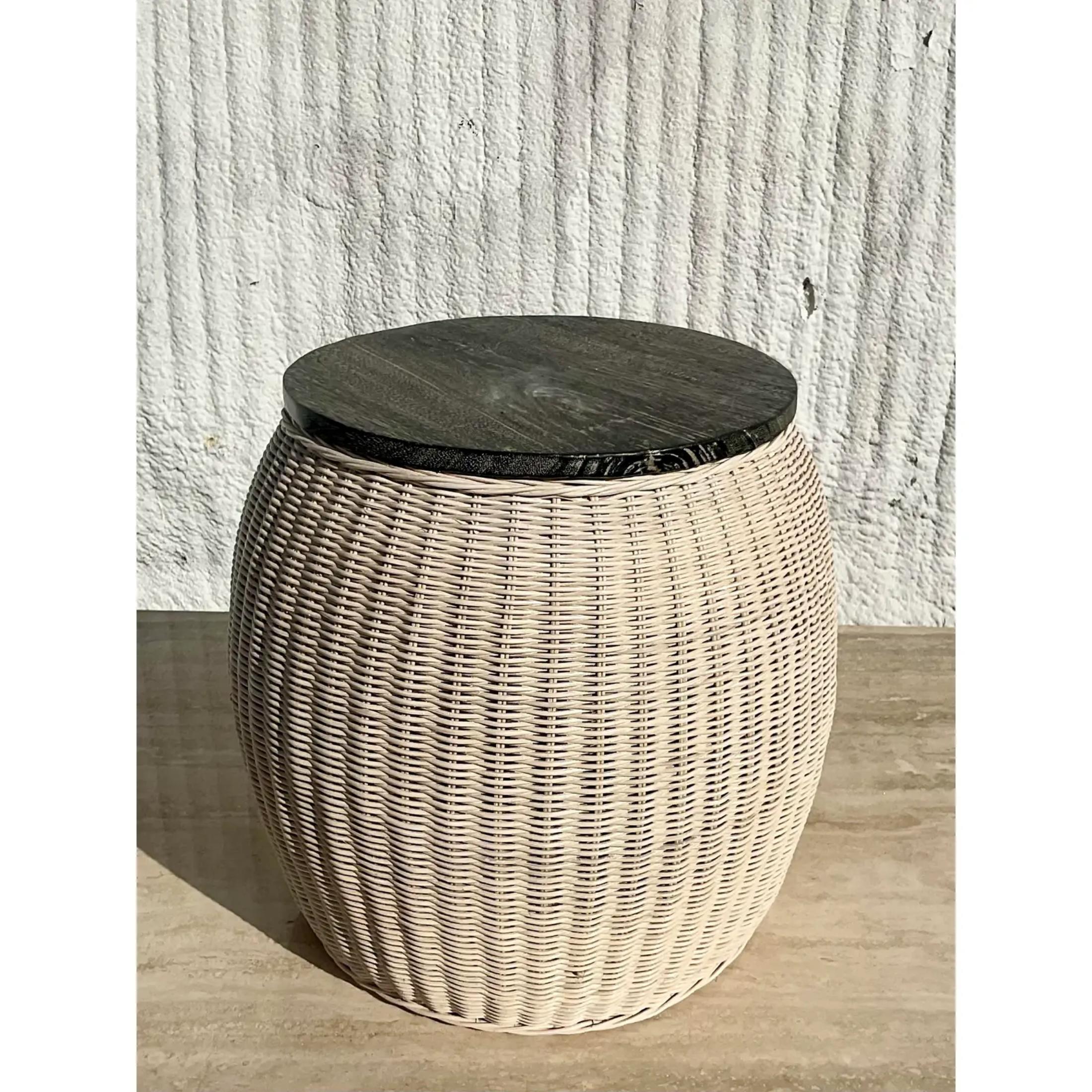 A fabulous Contemporary side table. Beautiful woven rattan with a limed ebony wood top. Chic in its simplicity. Perfect as a side table and or a easy to move drinks table. Super versatile. Acquired from a Palm Beach estate