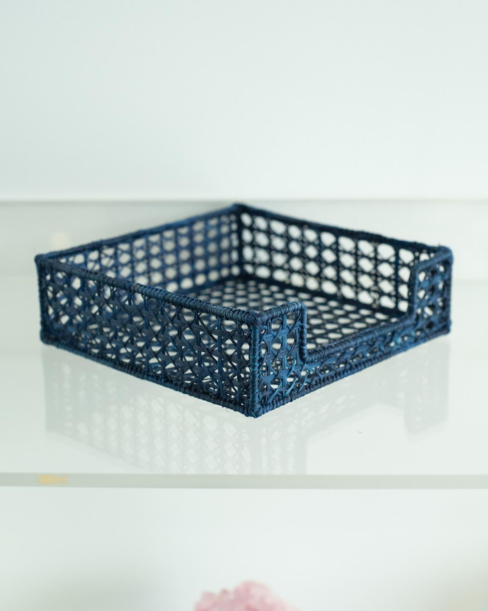 Uplift your table with this stunning handwoven rattan napkin holder. Finely crafted by expert artisans, this piece showcases the classical technique of weaving in a modern way. From Jean Michel Frank to the House of Dior, rattan has always had a