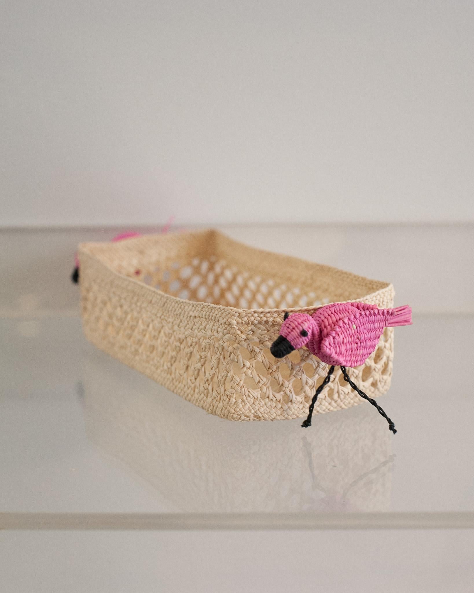 Uplift your table with this stunning handwoven rattan small rectangular basket with flamingos. Finely crafted by expert artisans, this piece showcases the classical technique of weaving in a modern way. From Jean Michel Frank to the House of Dior,