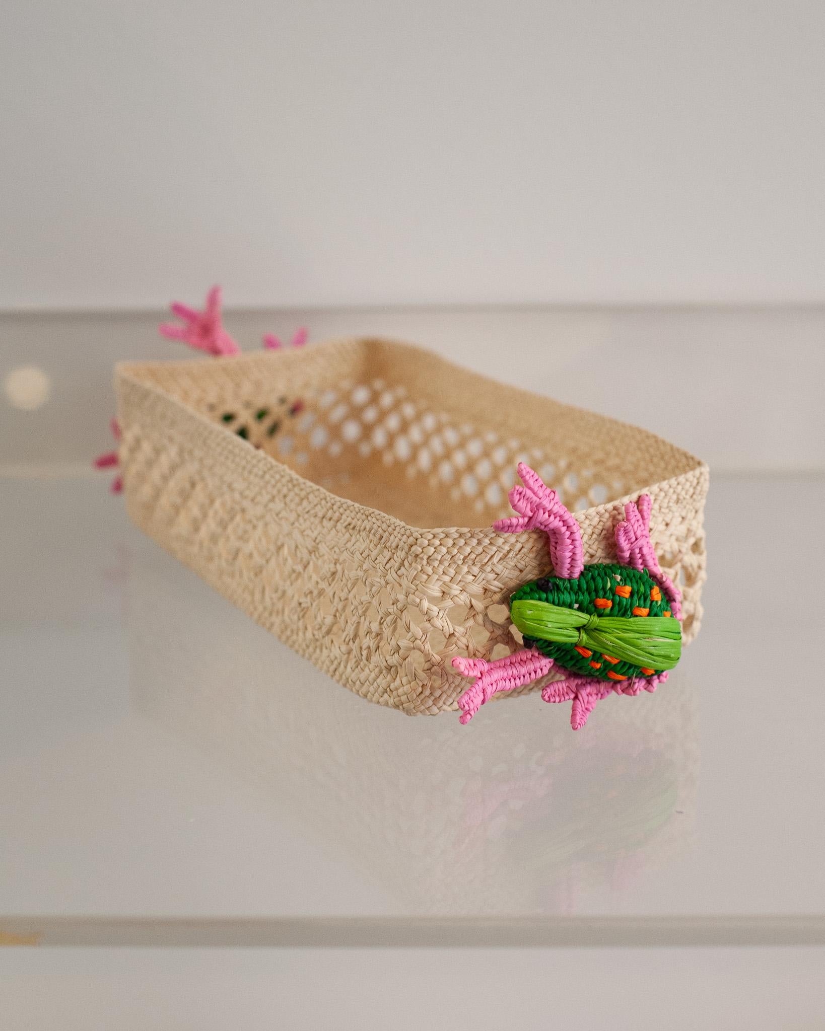 Uplift your table with this stunning handwoven rattan small rectangular basket with frogs. Finely crafted by expert artisans, this piece showcases the classical technique of weaving in a modern way. From Jean Michel Frank to the House of Dior,