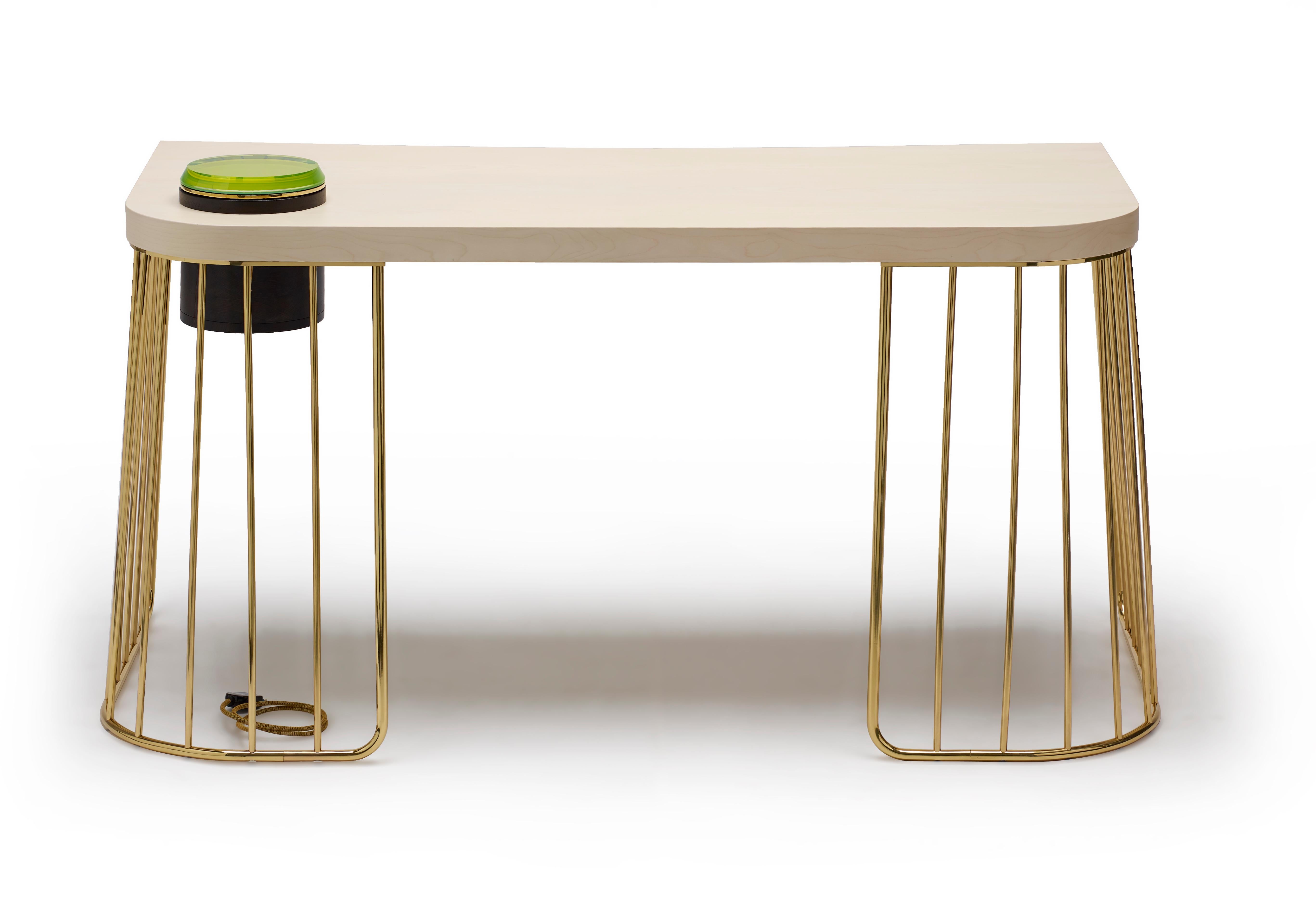 Elegant and decorative desk with incorporated hidden wiring system, to solve the problem of powering computer equipment or a light fixture on the desk.
Metal base in polished brass, top in wood material with bleached maple veneer. Desk designed