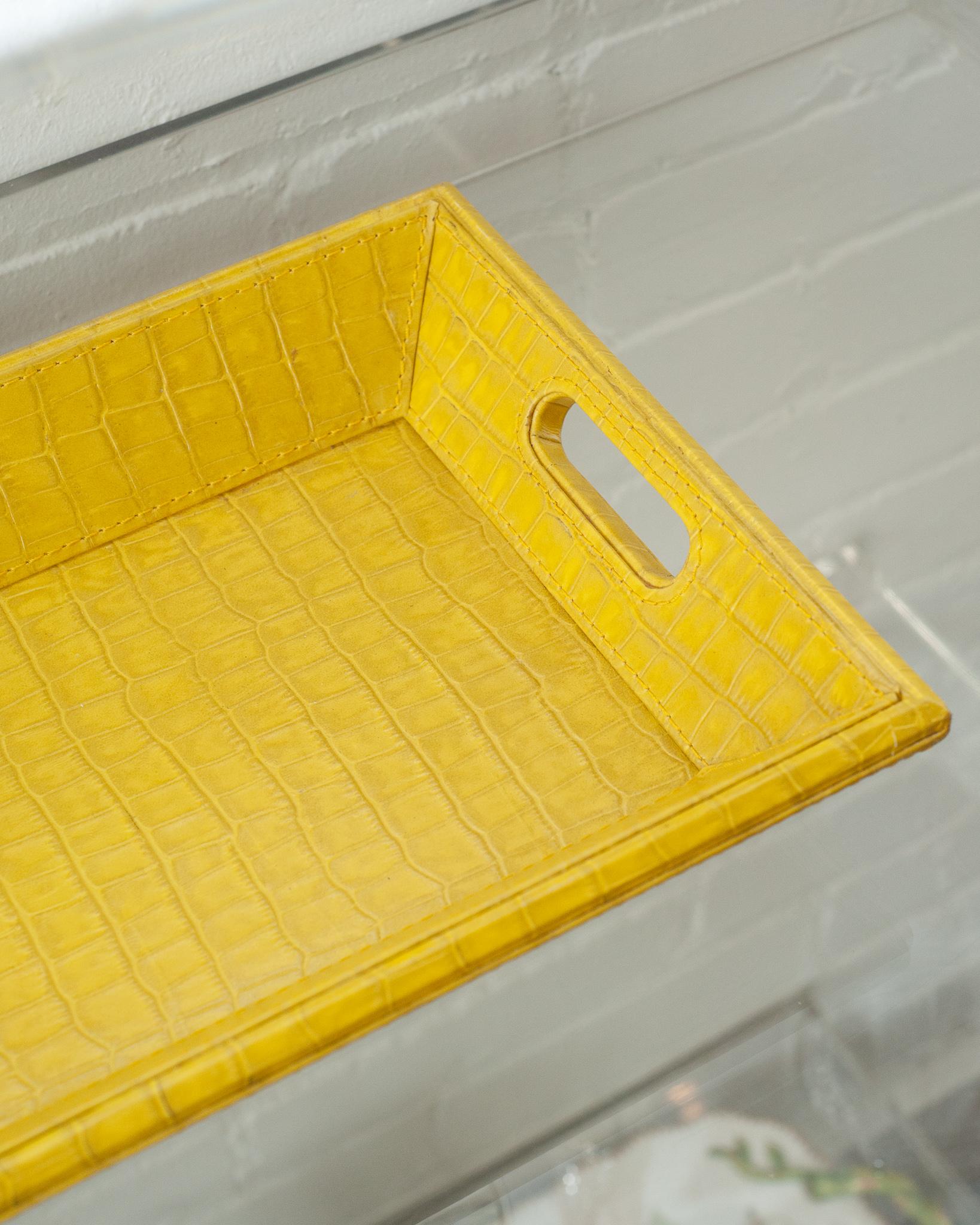 A beautiful yellow crocodile embossed leather tray, perfect for the desk, bedside table, or use as a serving piece. Fully wrapped in embossed leather with stitched panels, each tray has two openings for carrying.