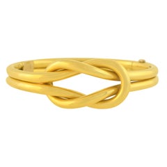 Contemporary Yellow Gold Love Knot Hinged Bangle Bracelet