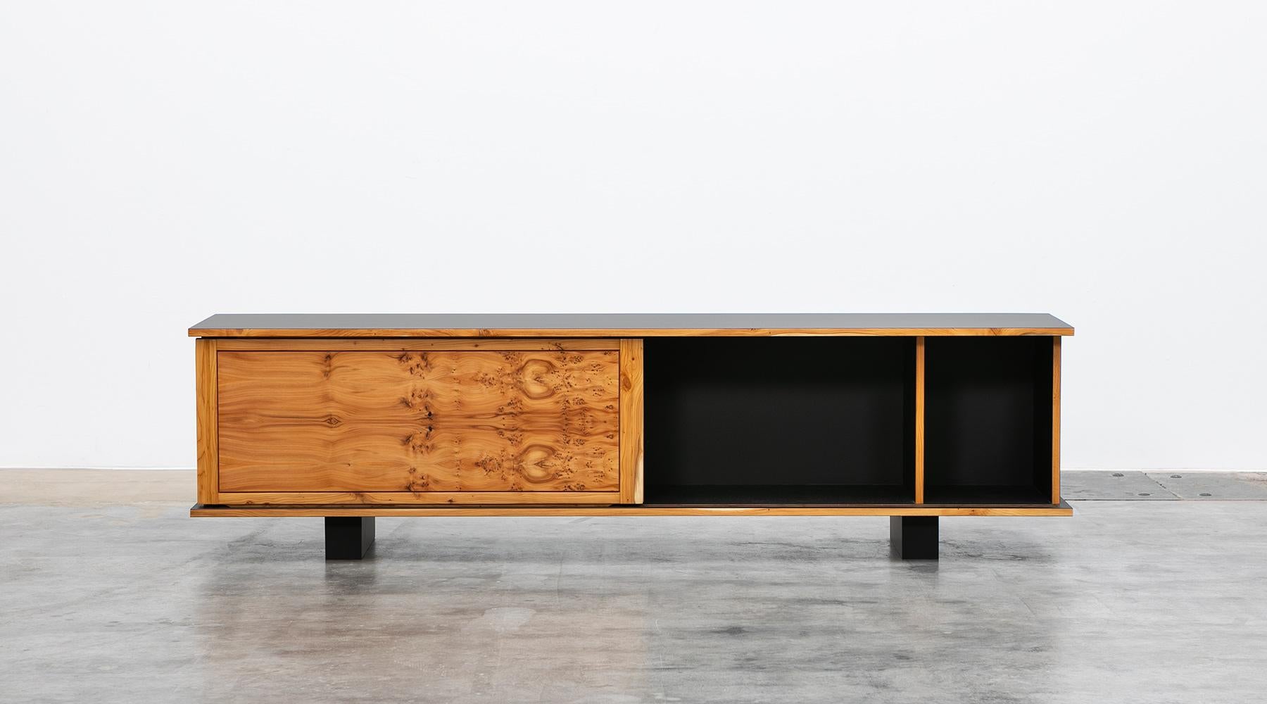 Sideboard by contemporary German artist Johannes Hock. The sliding doors of this unique piece are made of yew wood, the body is made of ultramatt black HPL, as well as the backside. Manufactured by Atelier Johannes Hock.