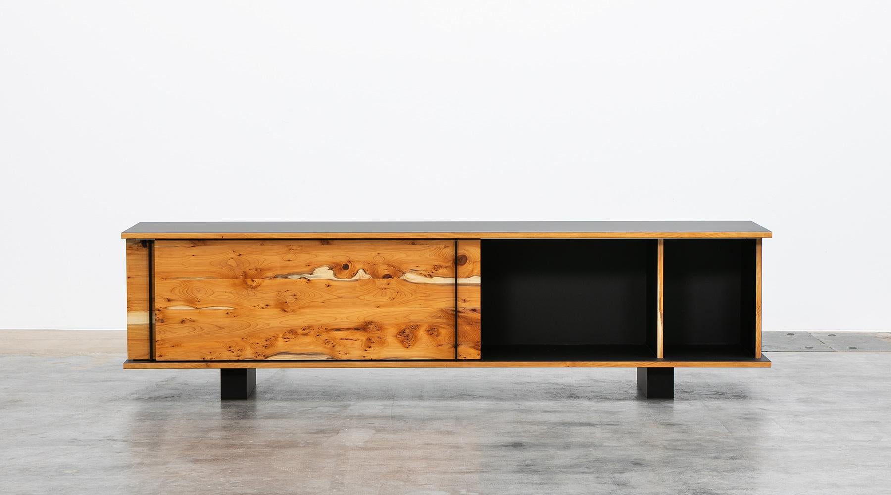 Sideboard by contemporary German artist Johannes Hock. The sliding doors of this unique piece are made of yew wood with ebony handles, the body is made of ultramatt black HPL, as well as the backside. Manufactured by Atelier Johannes Hock.