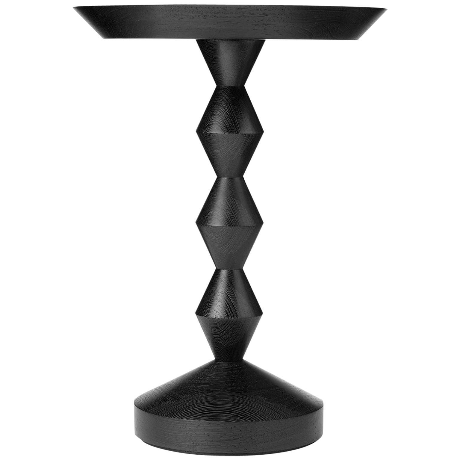 Like many of our tables this piece is turned from solid timber and therefore has a natural beauty, strength and durability. The slender zigzag shaped stem endows it with great elegance and delicacy. Shown here: in ebonised oak.

Each Stuart Scott