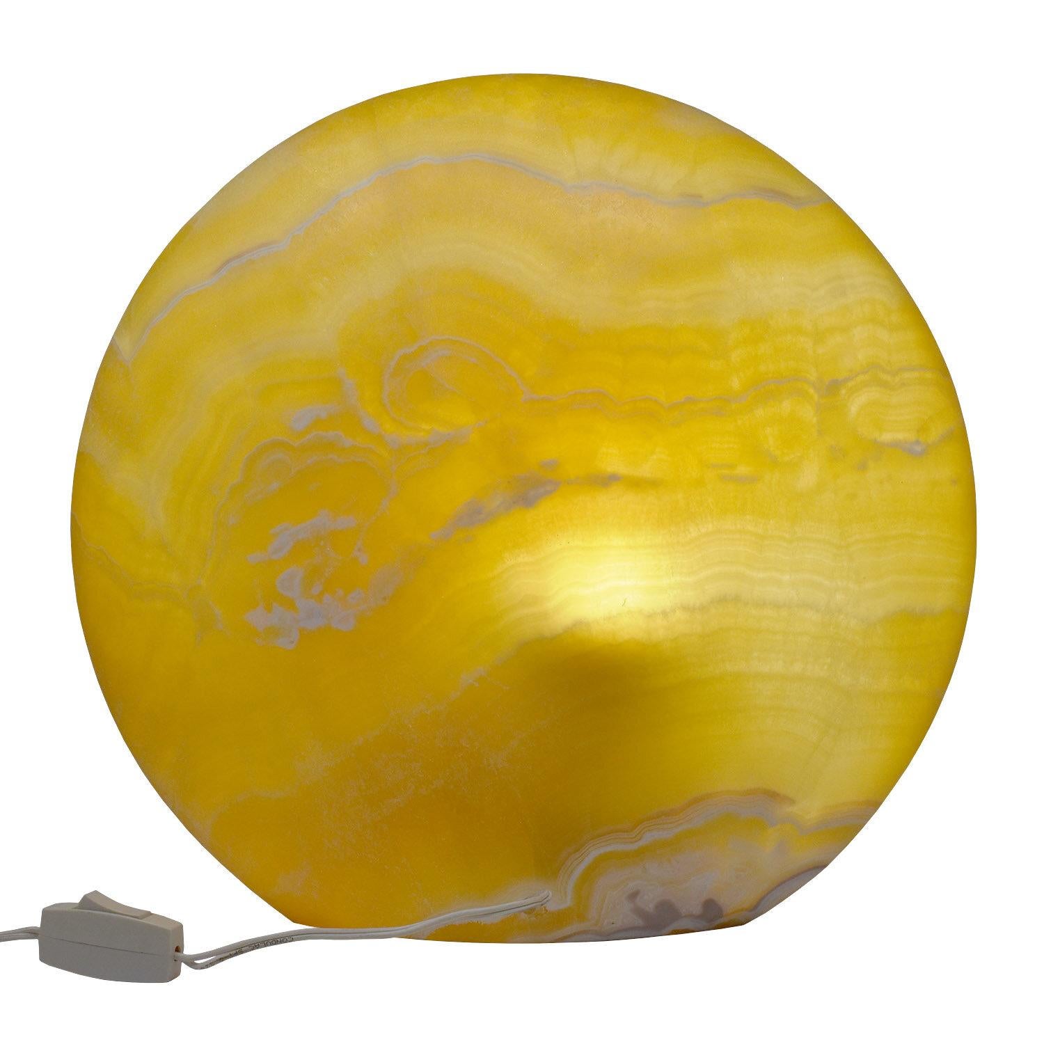 Contemporay natural yellow onyx table top lamp

Created from two thick slices of onyx, hollowed out to construct concave circles, forming a hollow for the bulb. The two sides are expertly connected together, with smooth, almost invisible seams,