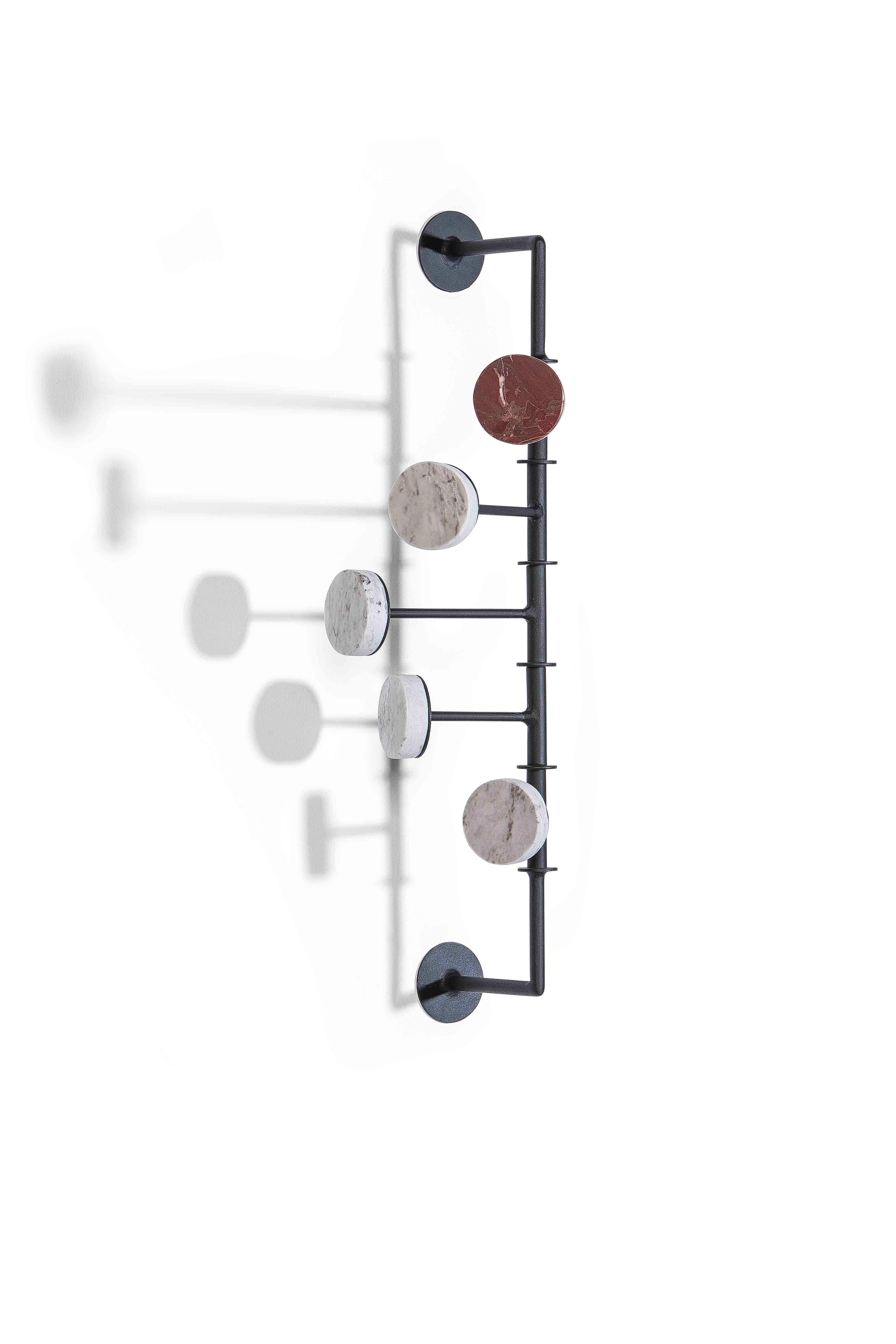 Articulated wall coat or hat rack, developed with Brazilian stones from the disposal of large marble industries. To remember the issue of sustainability, we always keep a stone different from the others, in order to perpetuate the issue of