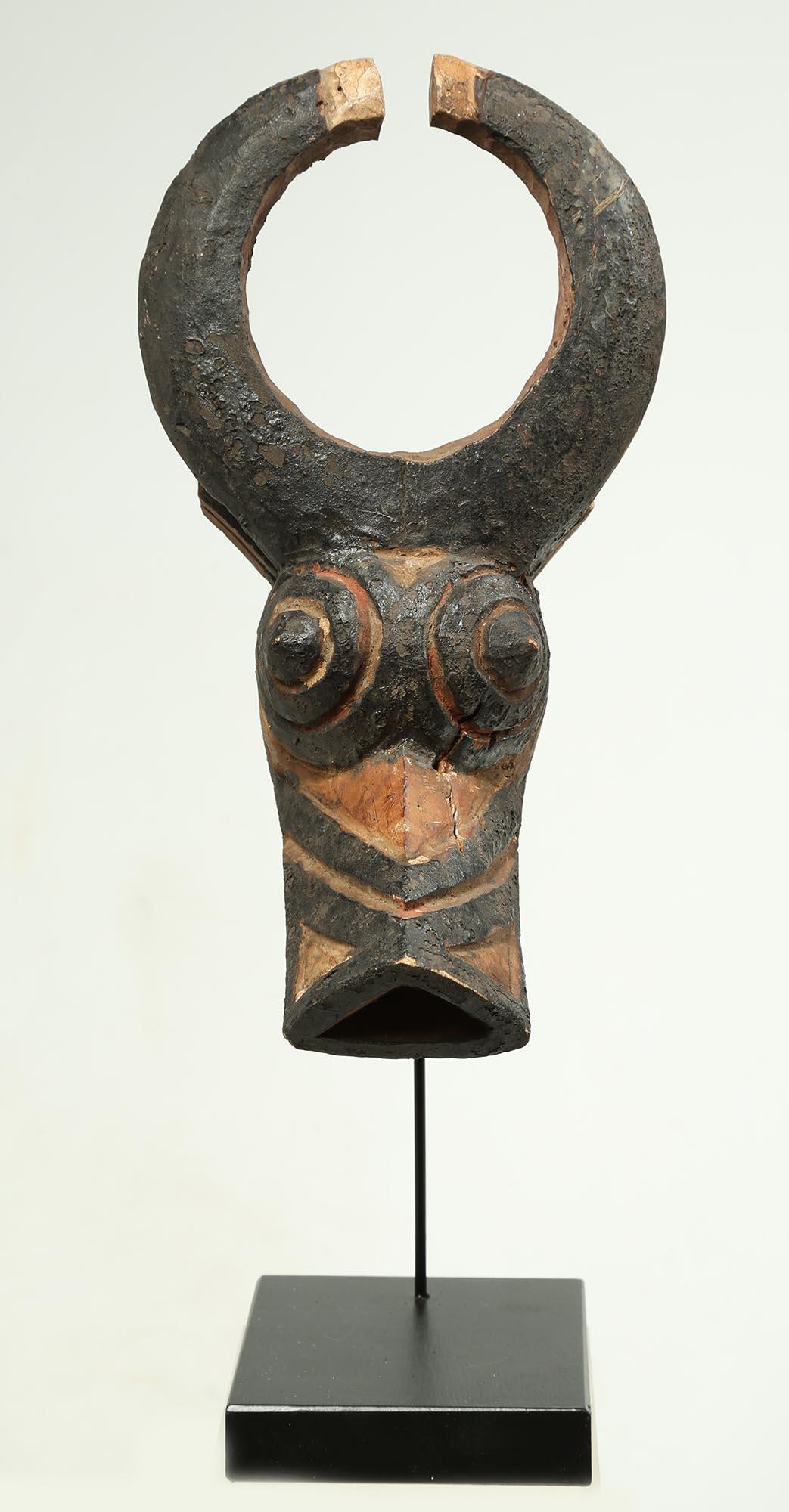 An appealing, contented-looking bush-cow mask with circular horns at the top. From the Bwa people Burkina Faso, early 20th century, Africa. Nicely balanced, symmetrical geometric forms and fine painting in black on softened white.
On custom wood