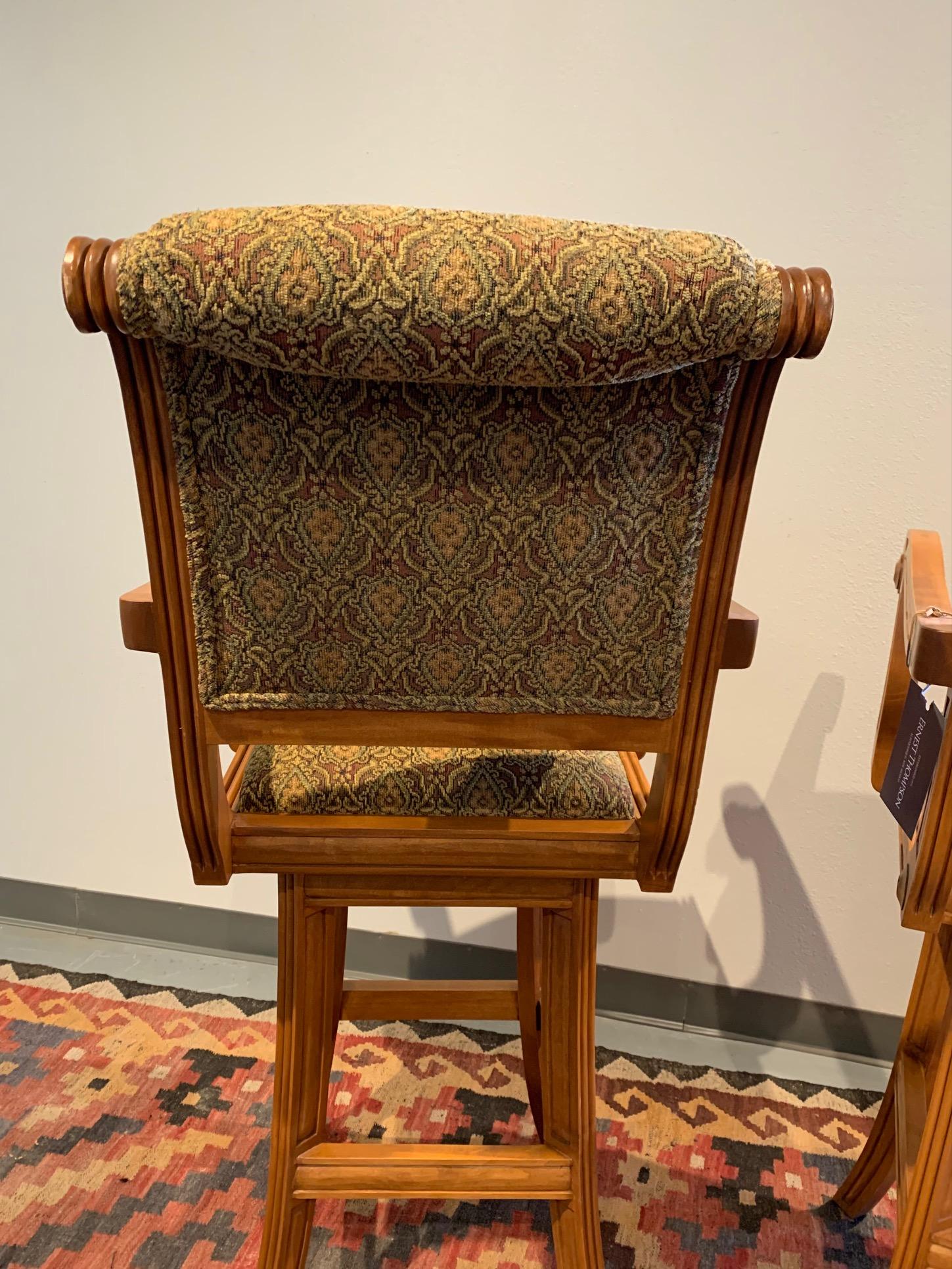 The Contessa Swivel Barstool is a classic in the Ernest Thompson line of furniture. 
Hand carved details and beautifully upholstered. These are showroom pieces that show some use. Fabric is in perfect condition. Extremely comfortable with full