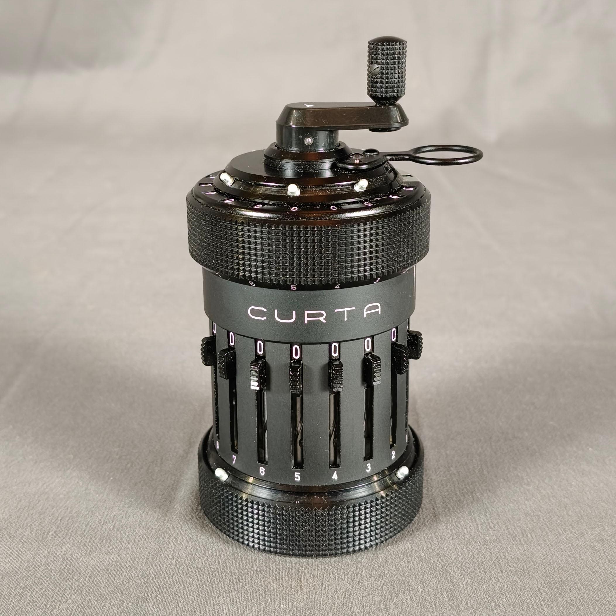 An important CURTA Type I mechanical calculator by Contina Ltd. Mauren. Made in Liechtenstein, manufactured in september 1968. Serial number 72161. Black body with 8 digits for data entry, 6 for revolution counter and 11 for result counter and