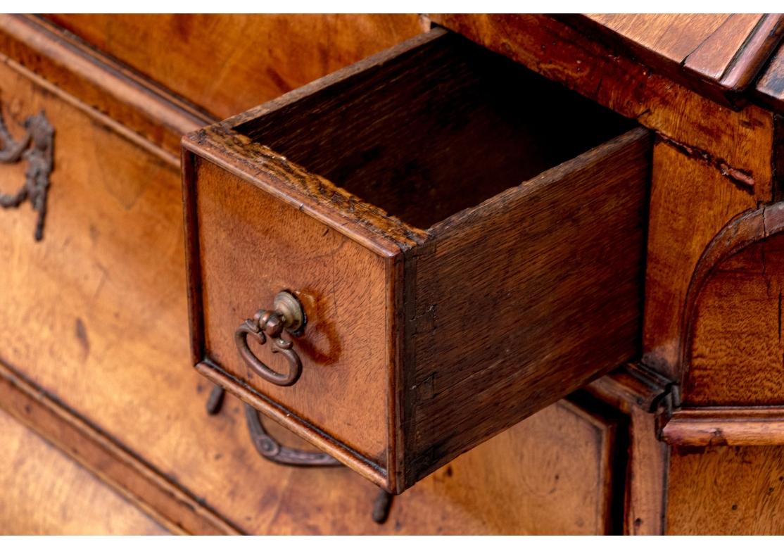 An 18th century Bombay form slant front desk that opens to reveal an inlaid central door with working key that reveals a compartment with a small drawer. Flanked by two 