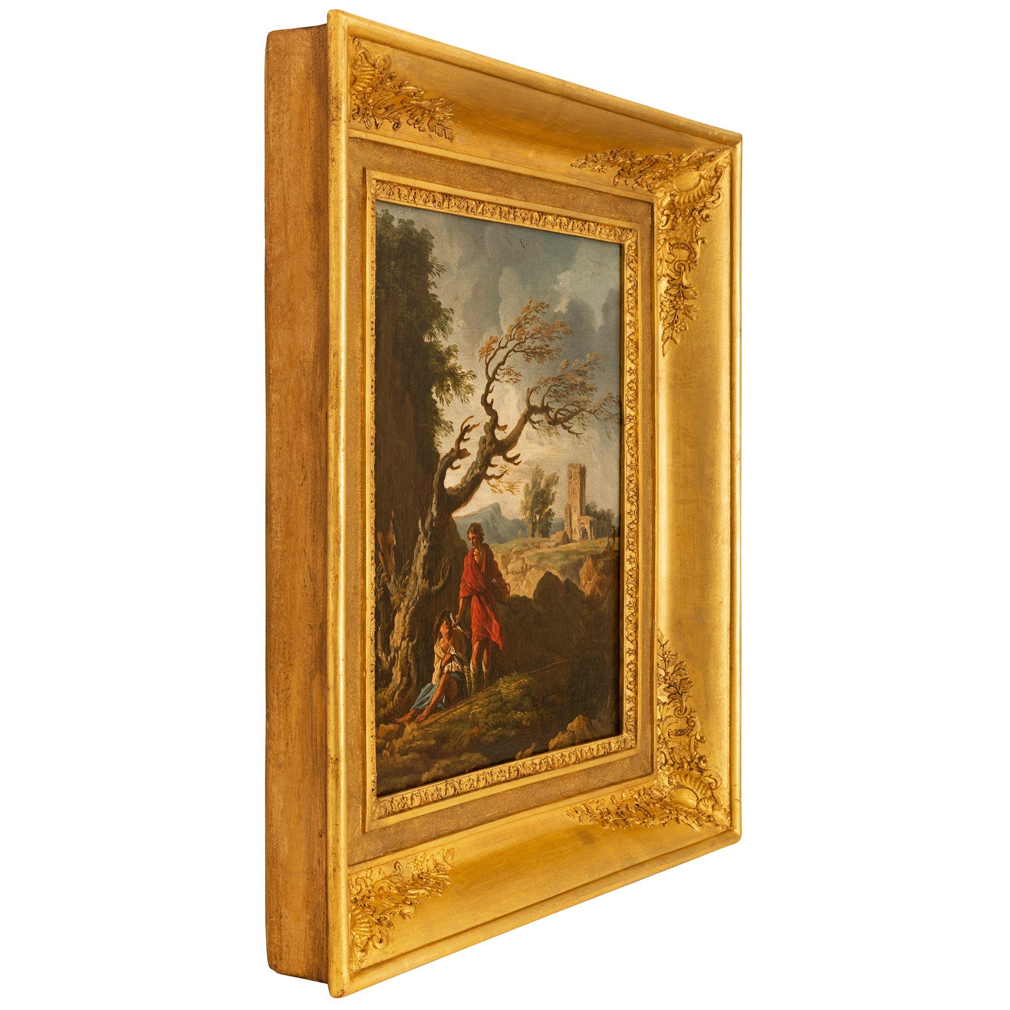 An exceptional and extremely decorative Continental 18th century oil on canvas painting in its original giltwood frame. The wonderfully executed painting depicts a handsome young man in a flowing red garment handing a fish to a man on the ground who