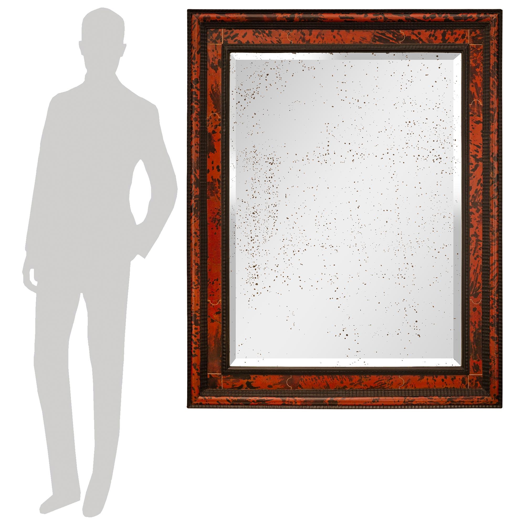 A stunning and most decorative Continental early 19th century Baroque st. Tortoiseshell and Ebonized Fruitwood mirror. This wonderful rectangular mirror retains its original beveled mirror plate set within a beautiful and unique wave like designed