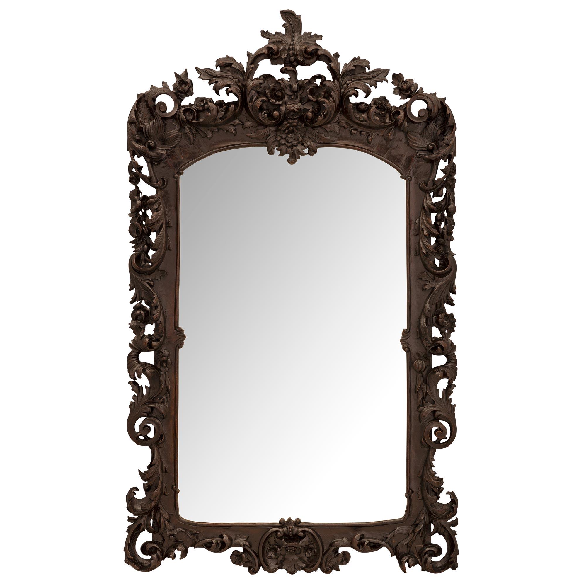 A beautiful and wonderfully executed Continental 19th century Baroque st. Walnut mirror. The mirror retains its original mirror plate framed within an elegant mottled wrap around carved fillet. Stunning richly carved scrolled acanthus leaves extend