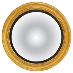Continental 19th century Giltwood and ebonized Fruitwood convex mirror
