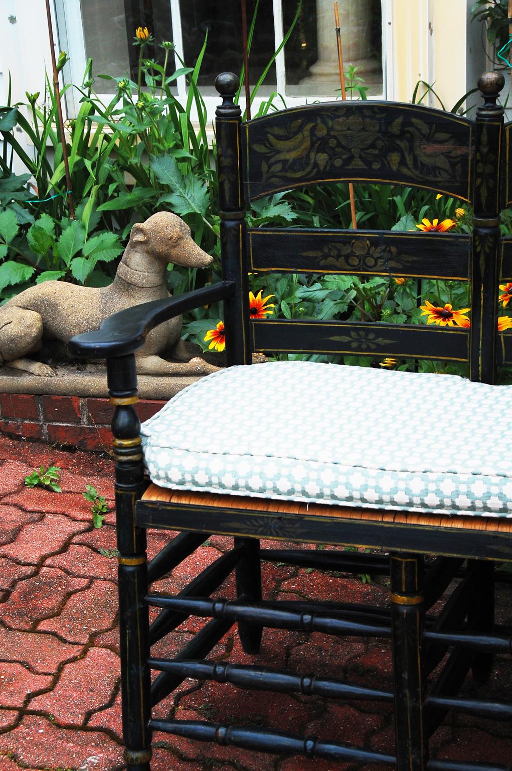 Continental ladderback bench with original stenciled decoration on a black/dark blue ground. The effect is of a black background but there are overtones of blue. The charming decoration on the ladders is stenciled in gold with classic motifs of a