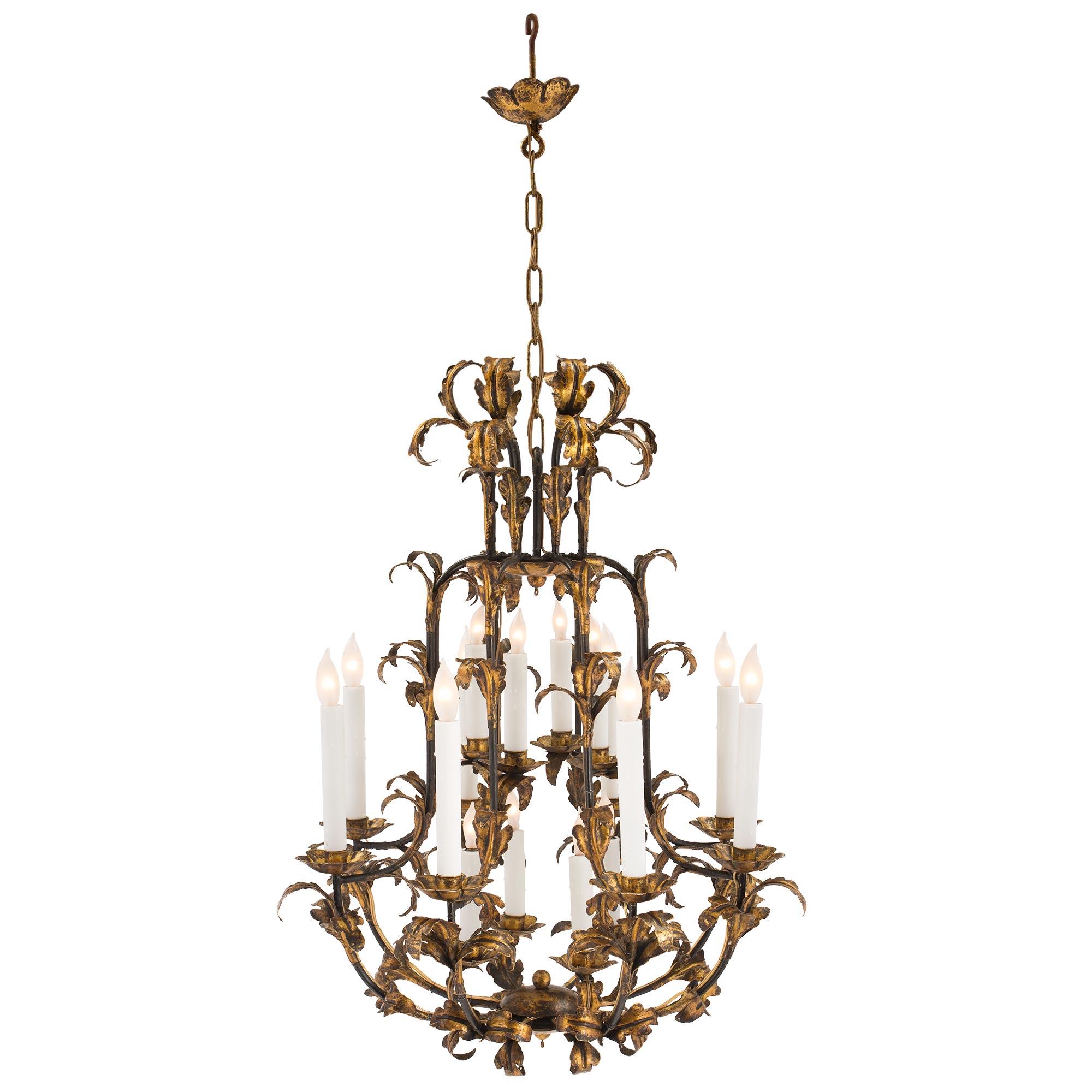 A charming Continental late 19th century Louis XV st. patinated and gilt metal sixteen light chandelier. The chandelier is centered by a bottom foliate reserve from where each of the eight extremely decorative arms branch out. Each arm is decorated