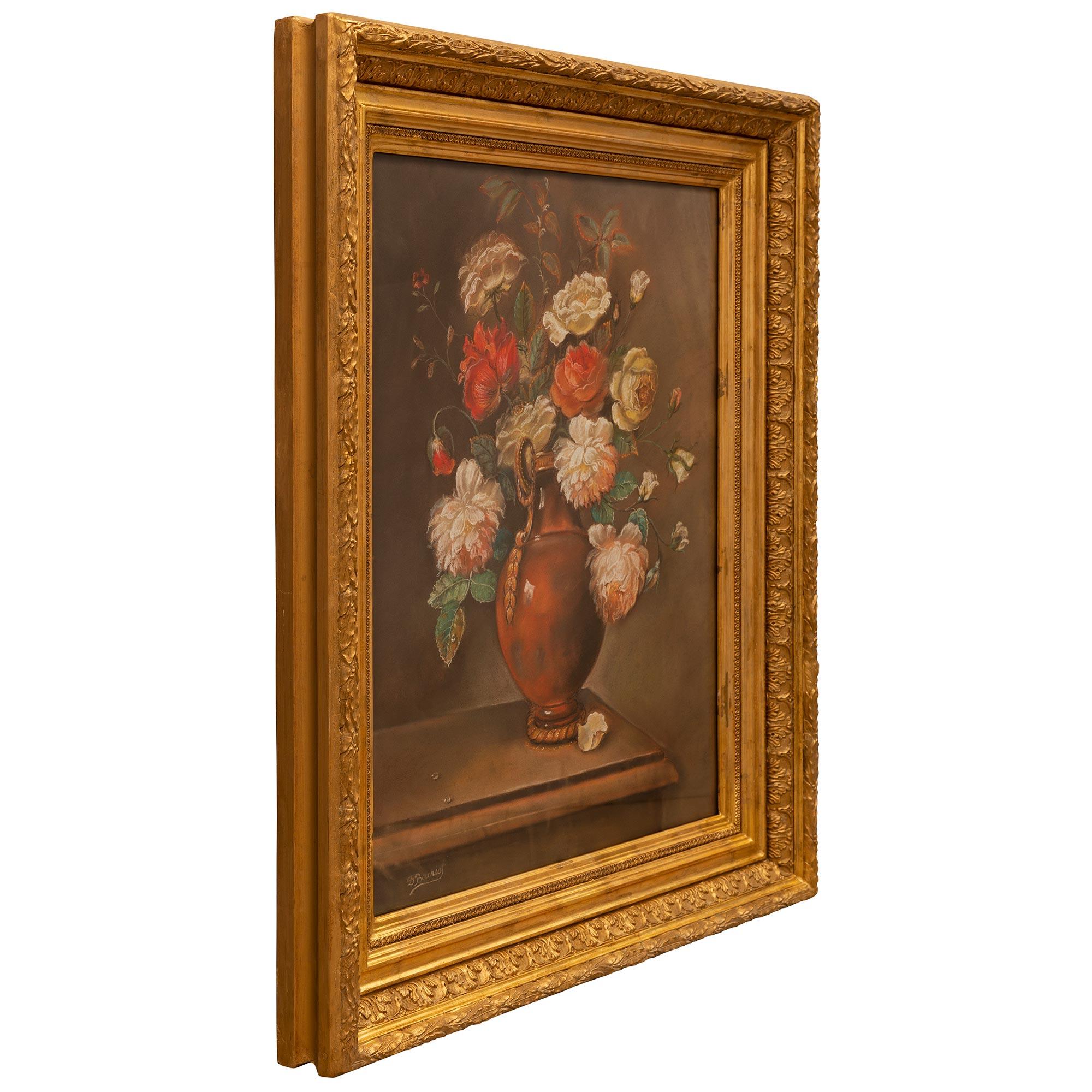 A beautiful Continental 19th century Louis XVI st. still life pastel set in its original giltwood frame. The pastel depicts a wonderfully executed flower arrangement with beautiful vivid colored flowers in a charming vase on a table with a fallen