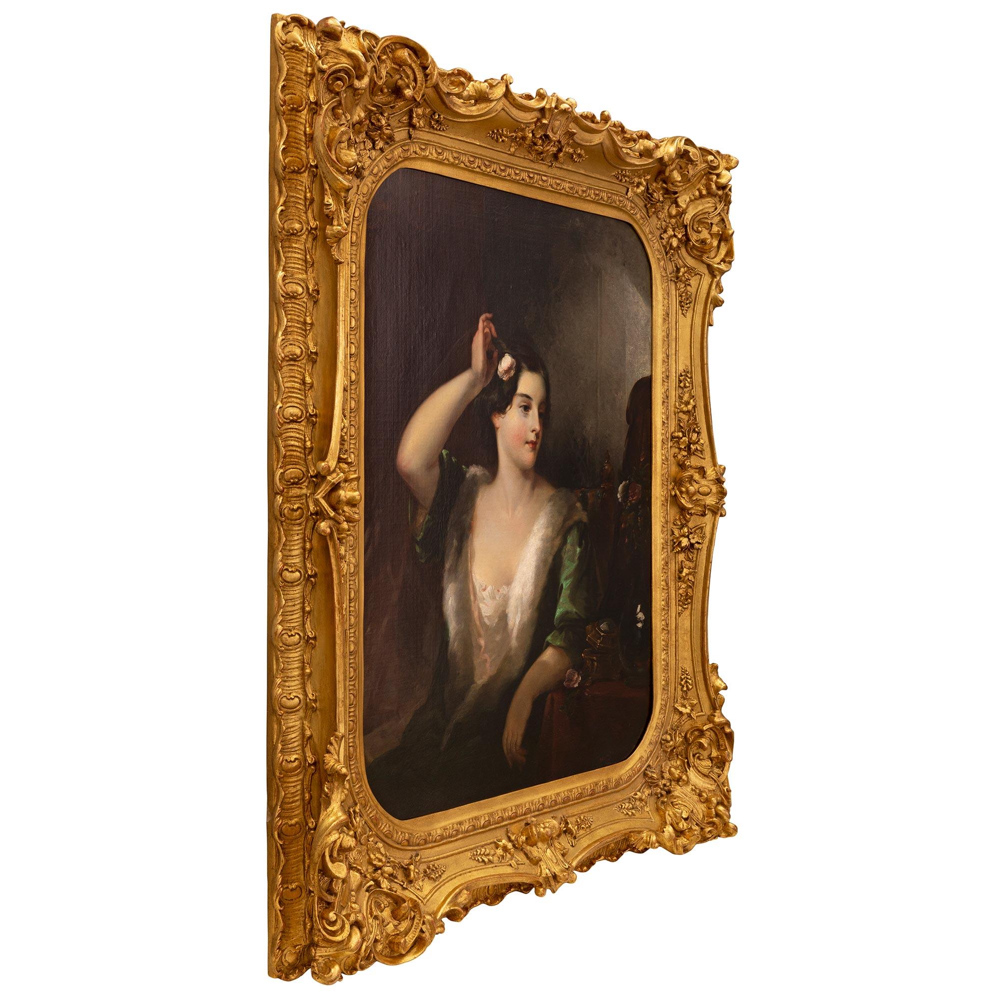 A superb and exceptionally high quality Continental 19th century oil on canvas painting in its original frame. The painting depicts a beautiful young lady dressed in an elegant gown with ermine trim. She is leaning on her dressing table where a