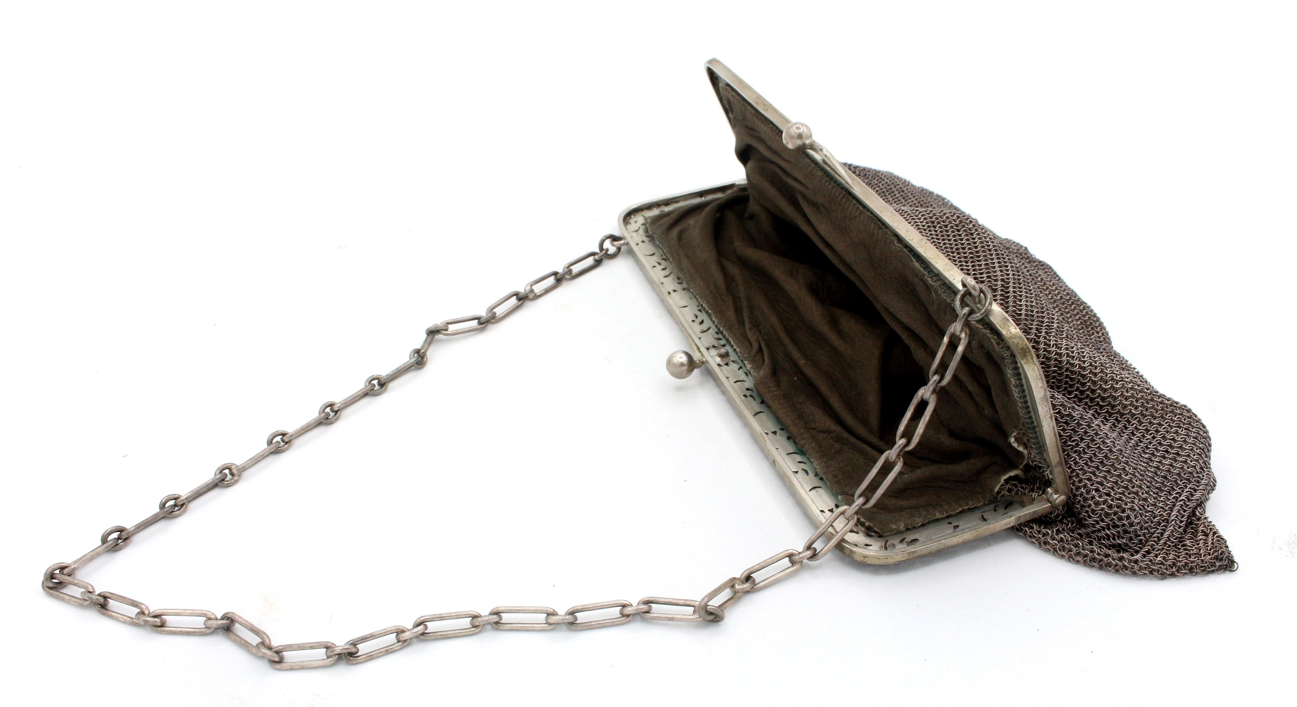 Continental 800 standard silver purse, late 19th-early 20th century. Reticulated entwined leaves & flowers supporting the woven silver mech bag with suede liner. Contains and as found coin purse of silver mesh. 9.40 troy oz. excluding the coin
